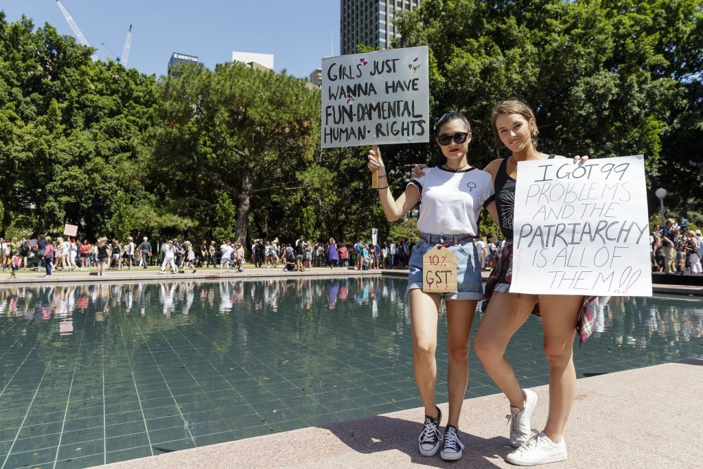 SYDNEY, NEW SOUTH WALES - JANUARY 21: Two women protest against new U.S. President Donald Trump on January 21, 2017 in Sydney, Australia. The marches in Australia were organised to show solidarity with those marching on Washington DC and around the world in defense of women's rights and human rights. (Photo by Brook Mitchell/Getty Images)