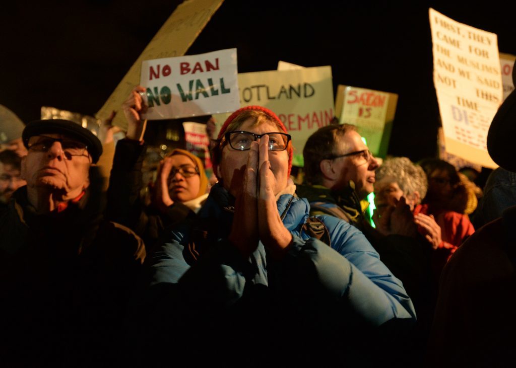 EDINBURGH, SCOTLAND - JANUARY 30: Crowds listen to speakers at the Mound as demonstrators march to the Scottish Parliament to protest against President Trump's Muslim travel ban to the USA on January 30, 2017 in Edinburgh, Scotland. President Trump signed an executive order on Friday banning immigration to the USA from seven muslim countries. This led to protests across America and today, a British petition asking for the downgrading of Trump's State visit passed one million signatures this morning. (Photo by Mark Runnacles/Getty Images)
