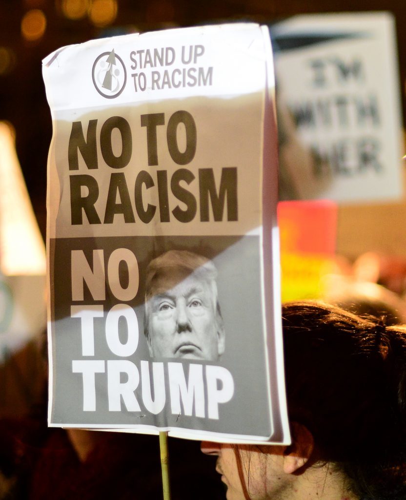 EDINBURGH, SCOTLAND - JANUARY 30: A placard is held aloft as crowds listen to a speaker at the Mound as demonstrators march to the Scottish Parliament to protest against President Trump's Muslim travel ban to the USA on January 30, 2017 in Edinburgh, Scotland. President Trump signed an executive order on Friday banning immigration to the USA from seven muslim countries. This led to protests across America and, today, in the UK a British petition asking for the downgrading of Trump's State visit passed one million signatures this morning. (Photo by Mark Runnacles/Getty Images)