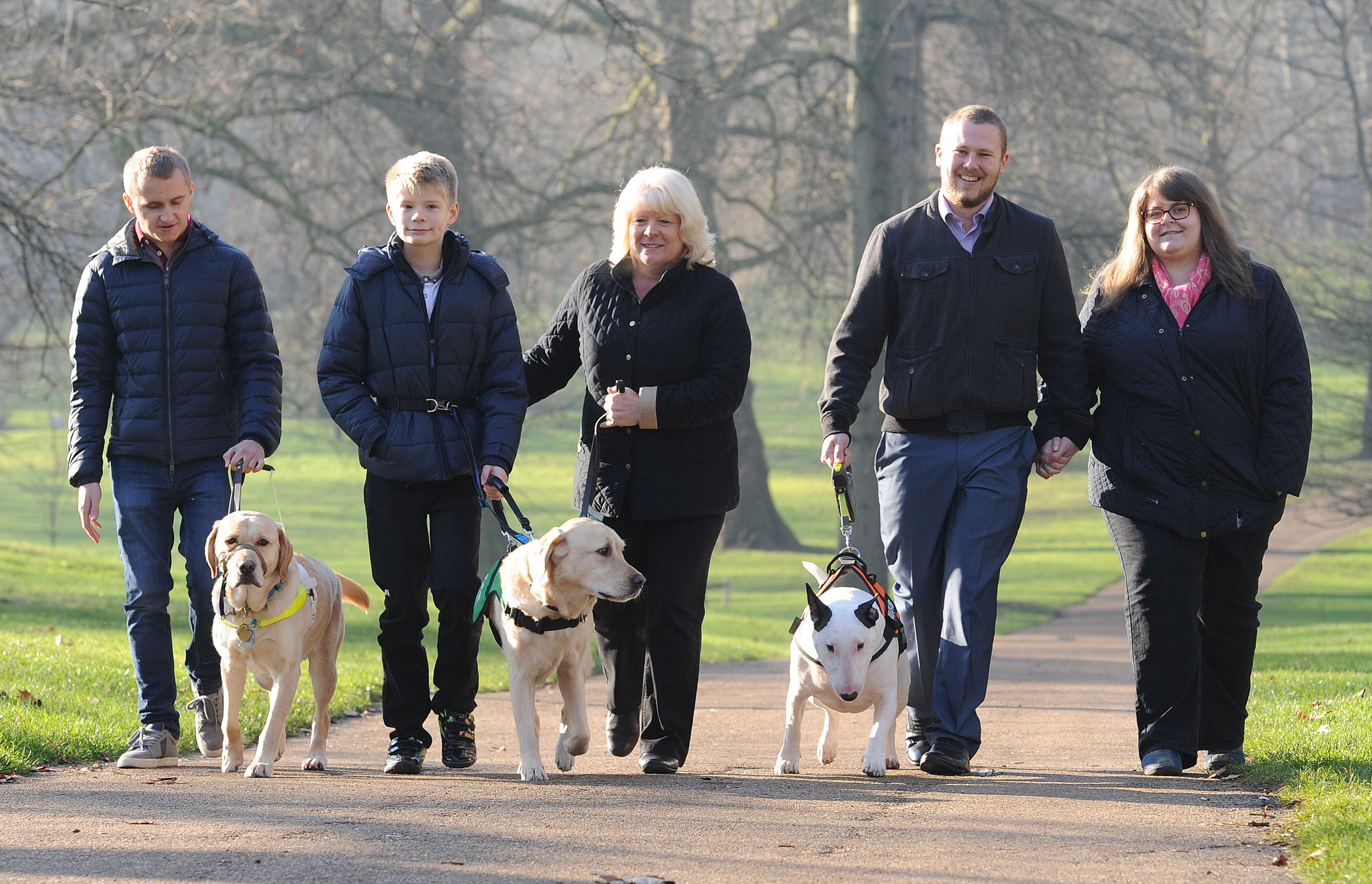 Nathan Edge, 22, from  with Hudson his guide dog; Joel Sawyer, 13 and mother Janet with Caddie, his Labrador Retriever assistance dog and Sally Deegan, 26 and husband Ciaron, with Bull Terrier Bowser (Nick Ansell/PA Wire)
