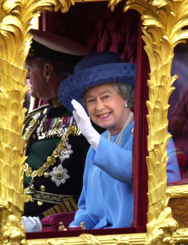 Britain's Queen Elizabeth II waves to the crowd as she rides, in the Gold State coach from Buckingham Palace to St Paul's Cathedral for a service of Thanksgiving to celebrate to her Golden Jubilee. 
