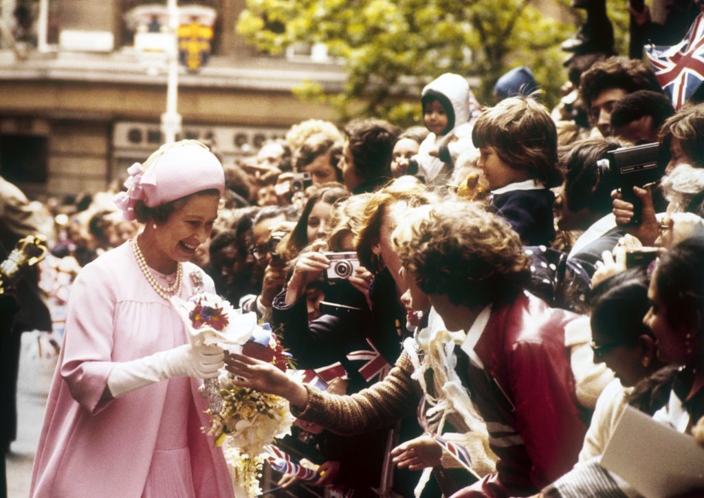 Queen Elizabeth II accepts a posy of flowers from a well-wisher during her 'walkabout' in the City of London after the Thanksgiving Service for the Silver Jubilee at St Paul's Cathedral.