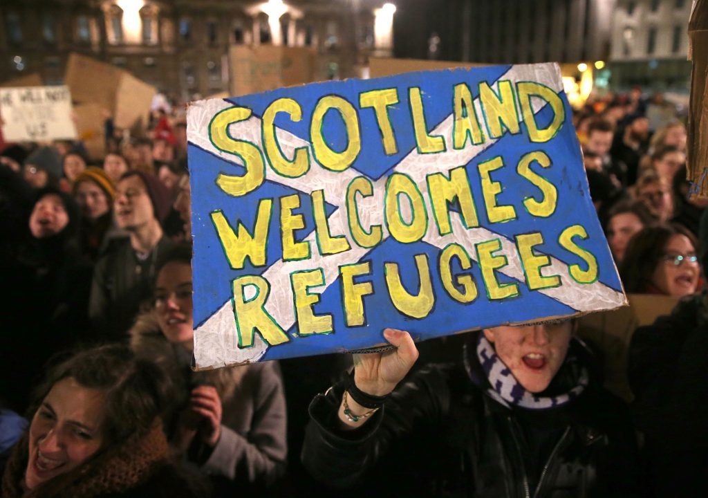 Demonstrators during a protest in Glasgow against US President Donald Trump's controversial travel ban on refugees and people from seven mainly-Muslim countries. PRESS ASSOCIATION Photo. Picture date: Monday January 30, 2017. Photo credit should read: Andrew Milligan/PA Wire