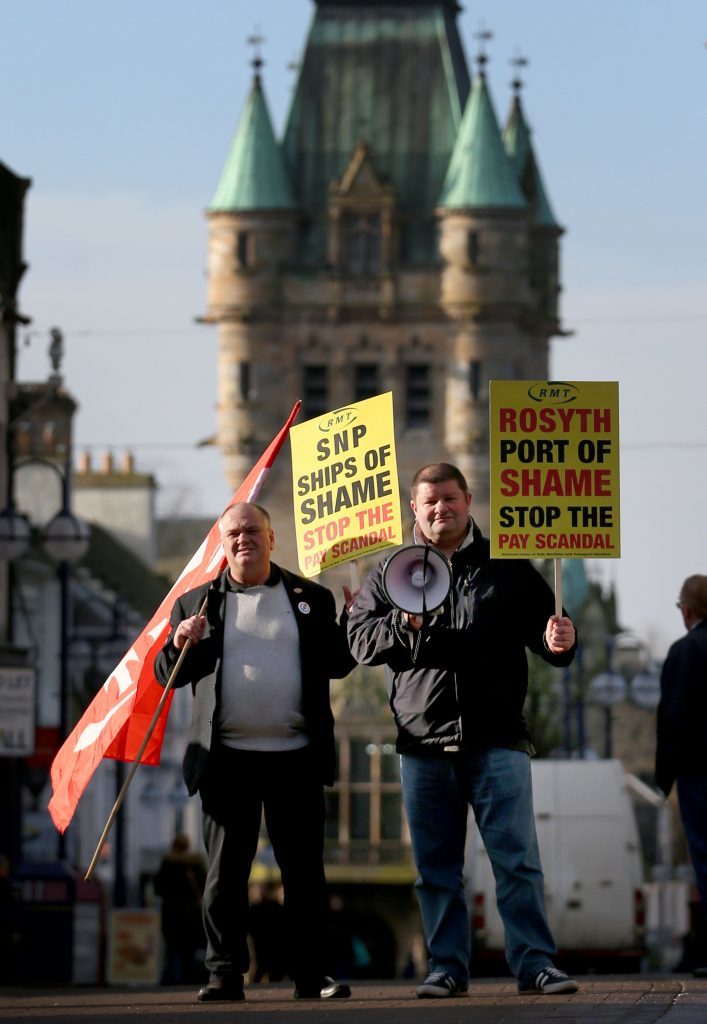 Brian Reynolds (left) and Gordon Martin take part in a demonstration held by RMT members . The Lithuanian-registered Finlandia Seaways, DFDS freight service operating between Rosyth in Fife and Zeebrugge in Belgium, employed Lithuanian seafarers on rates of pay as low as £1.64 per hour in 2015, according to the RMT. (Jane Barlow/PA Wire)