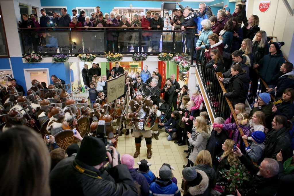 Lyle Hair, the Quizer Jarl, sings with the Jarl Squad dressed in Viking suits in the Toll Clock Shopping Centre during the parade through the street in Lerwick on the Shetland Isles during the Up Helly Aa Viking festival. PRESS ASSOCIATION Photo. Picture date: Tuesday January 31, 2017. See PA story SCOTLAND Vikings. Photo credit should read: Jane Barlow/PA Wire