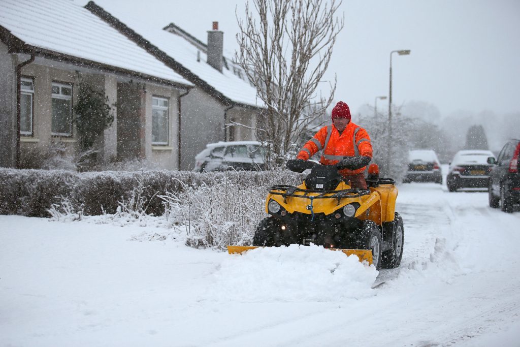 Jim Dunbar plows snow in Braco, near Stirling. (Andrew Milligan/PA Wire)
