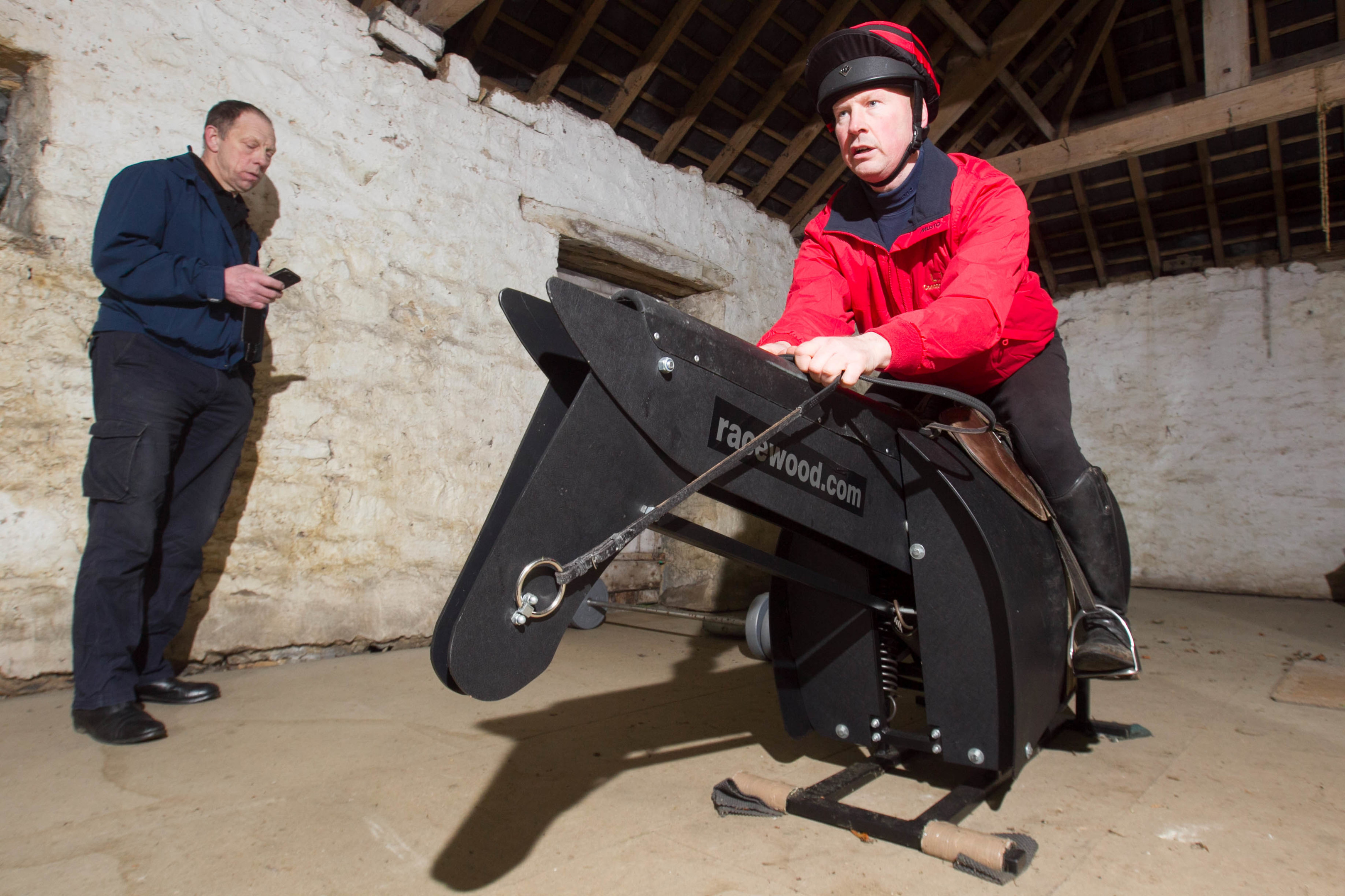 Scott on the mechanical training horse with Tim the trainer. (Sunday Post)