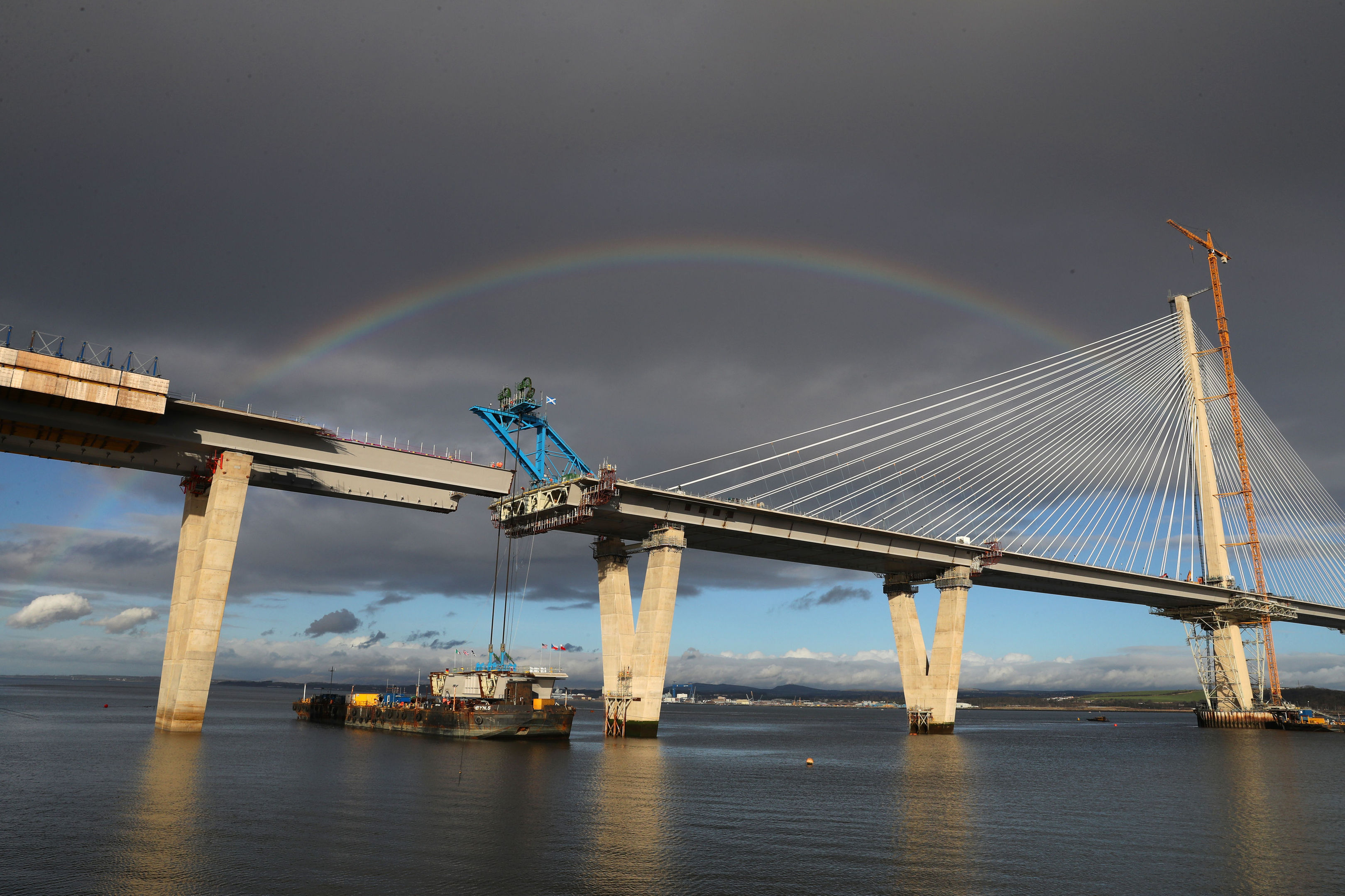 A rainbow is seen as cables are placed on a section of the new Queensferry Crossing bridge on a barge ready to lift into place (Andrew Milligan/PA Wire)