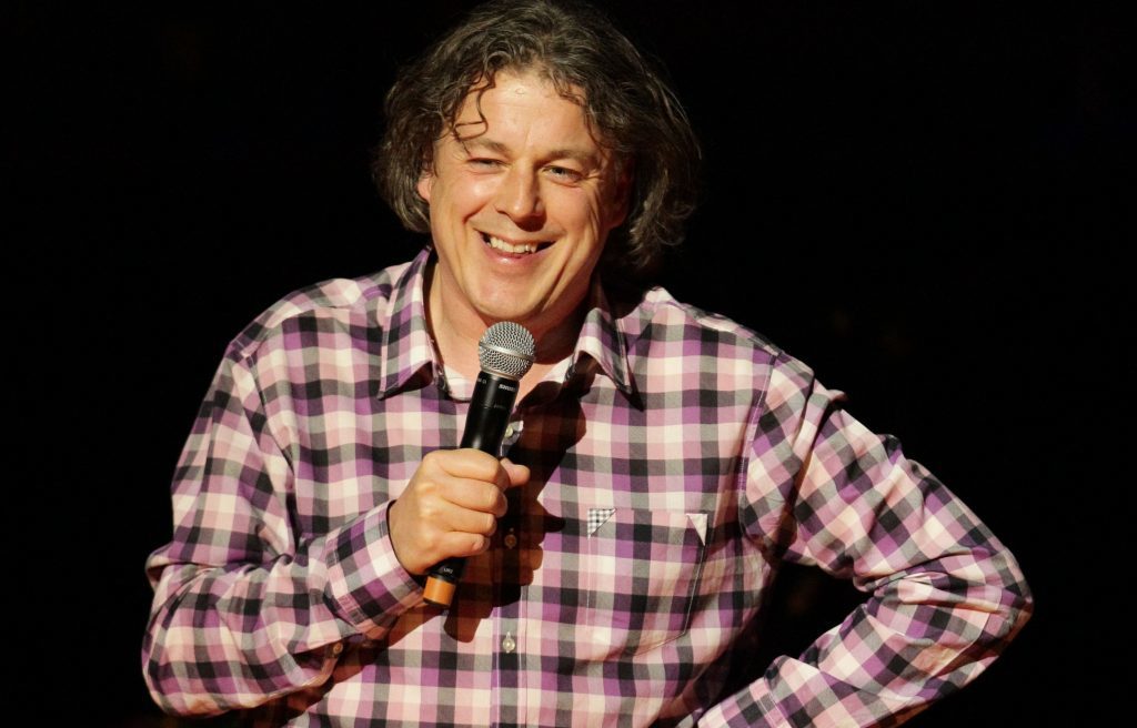 Alan Davies on stage (PA Wire)