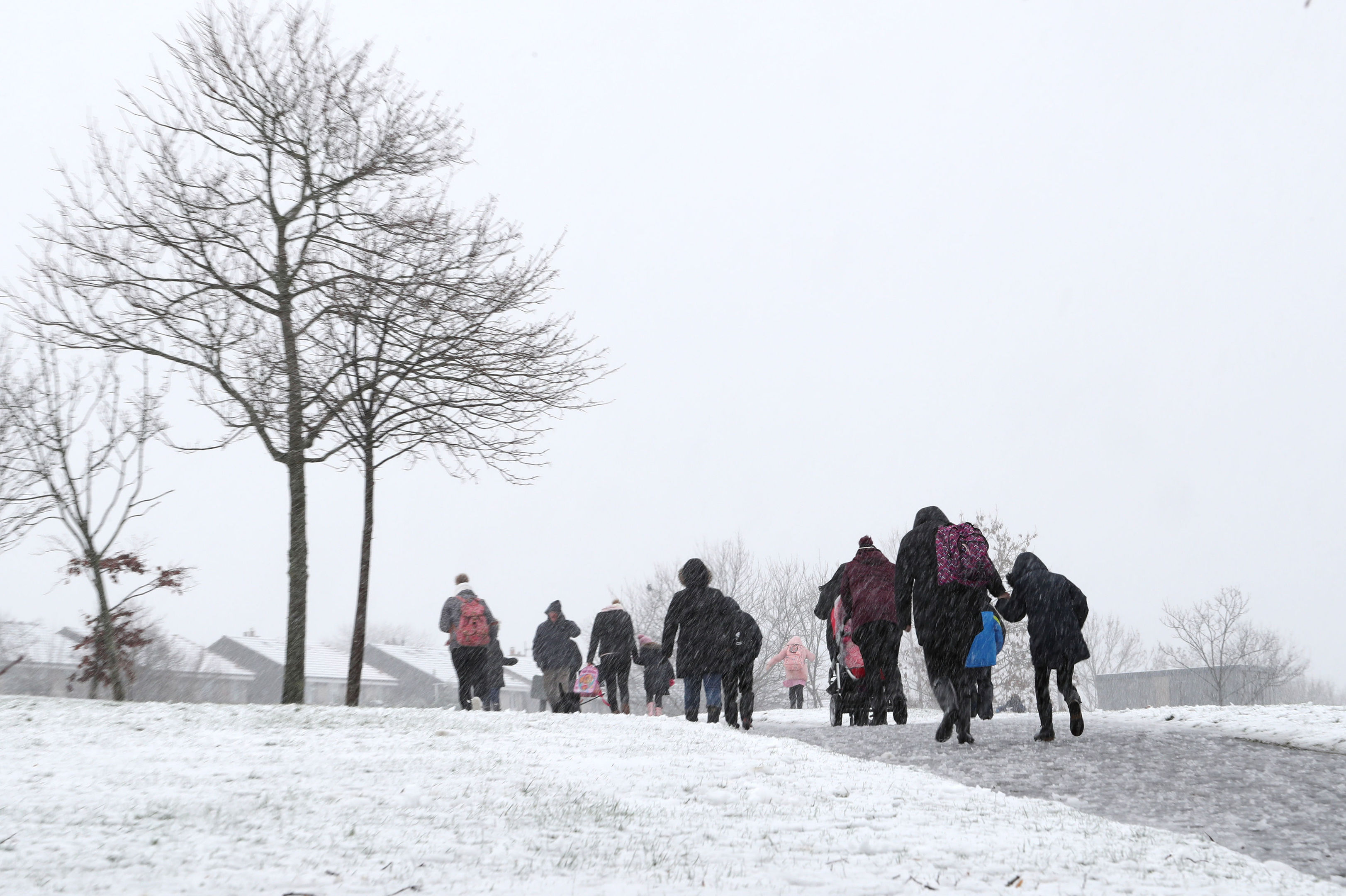 People make their way through the snow in Mauricewood Park in Penicuik, Midlothian, as flights have been cancelled and commuters were warned they faced delays after Storm Doris reached nearly 90mph (Jane Barlow/PA Wire)