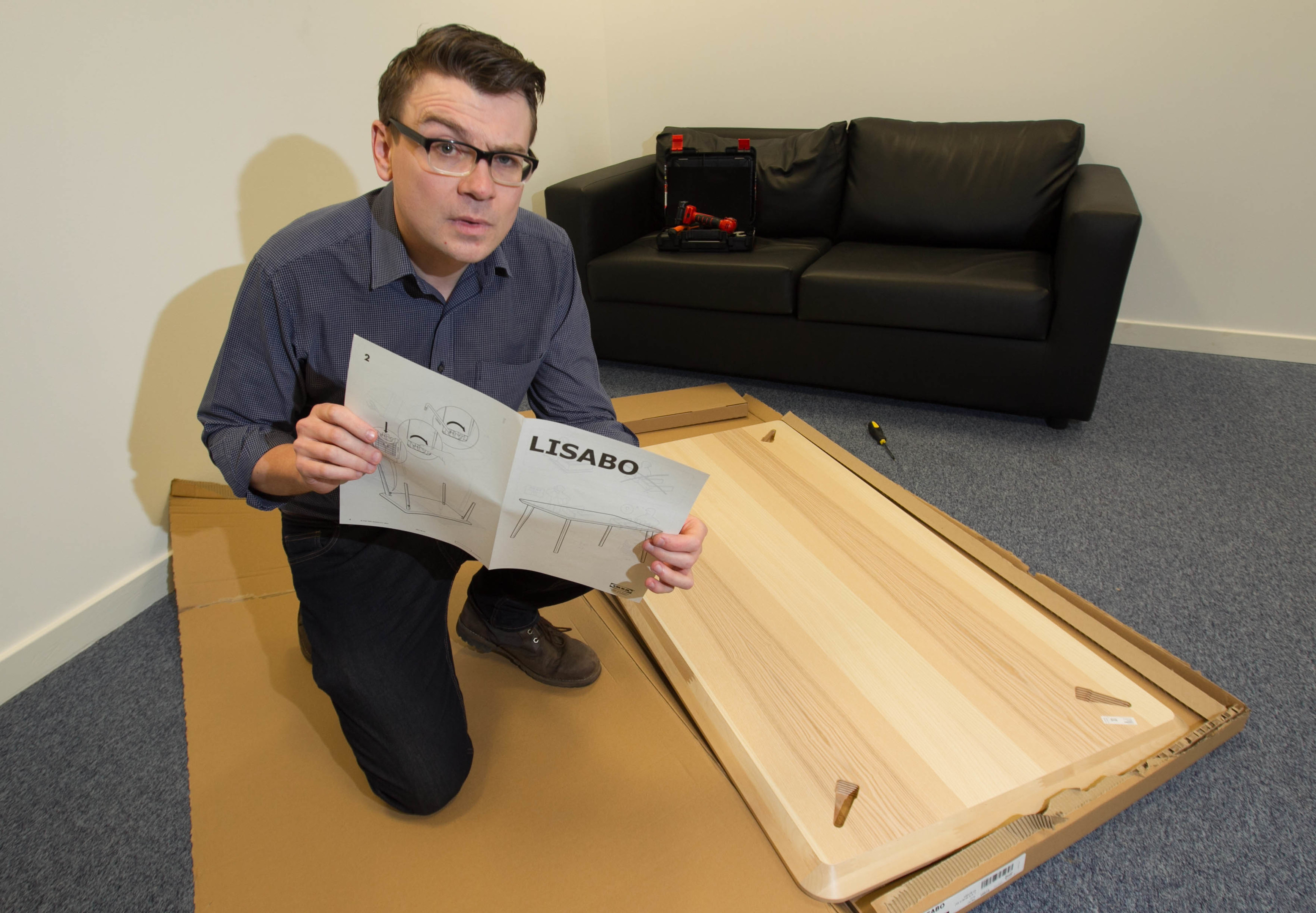 Reporter Stevie Gallacher builds an ikea table in under 10mins. (Chris Austin)