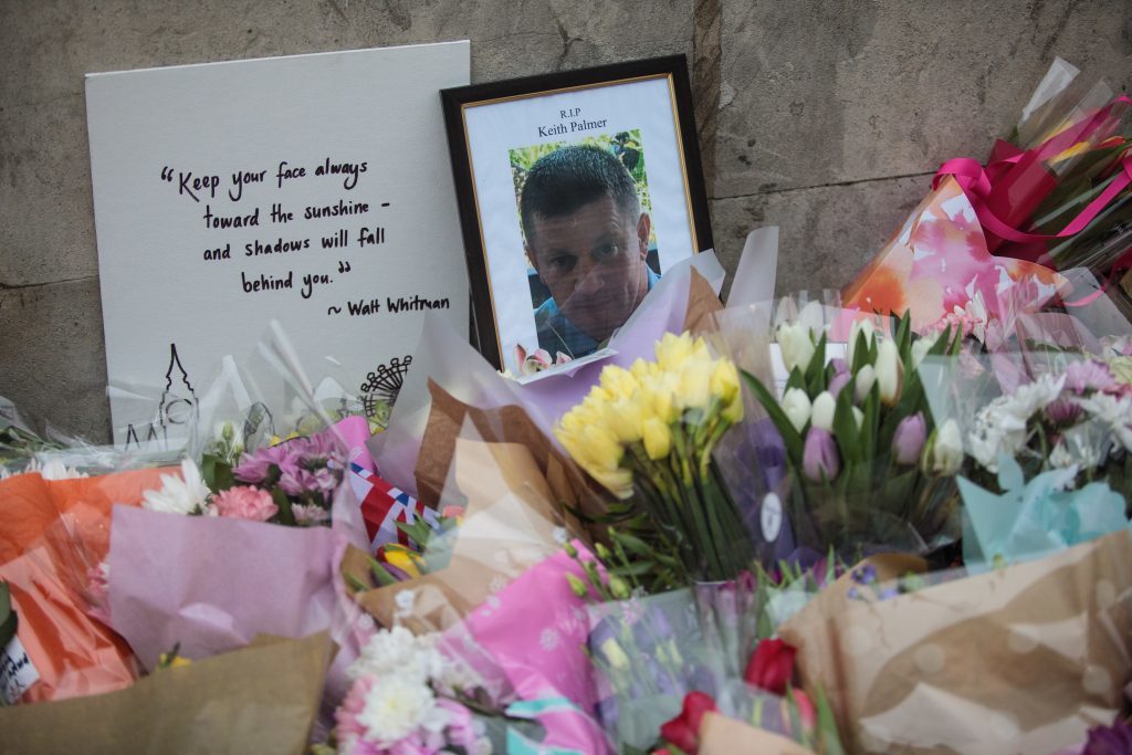 Floral tributes and a photograph of PC Keith Palmer lay outside the the Houses of Parliament (Jack Taylor/Getty Images)