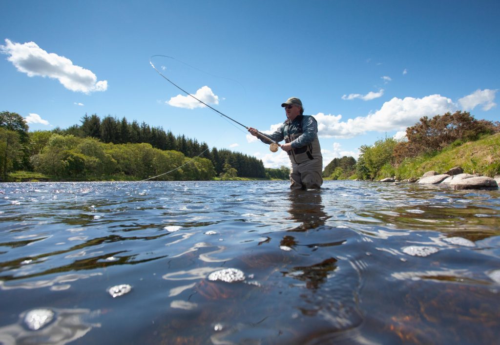 An angler fishing for salmon at the River Dee (Alamy)