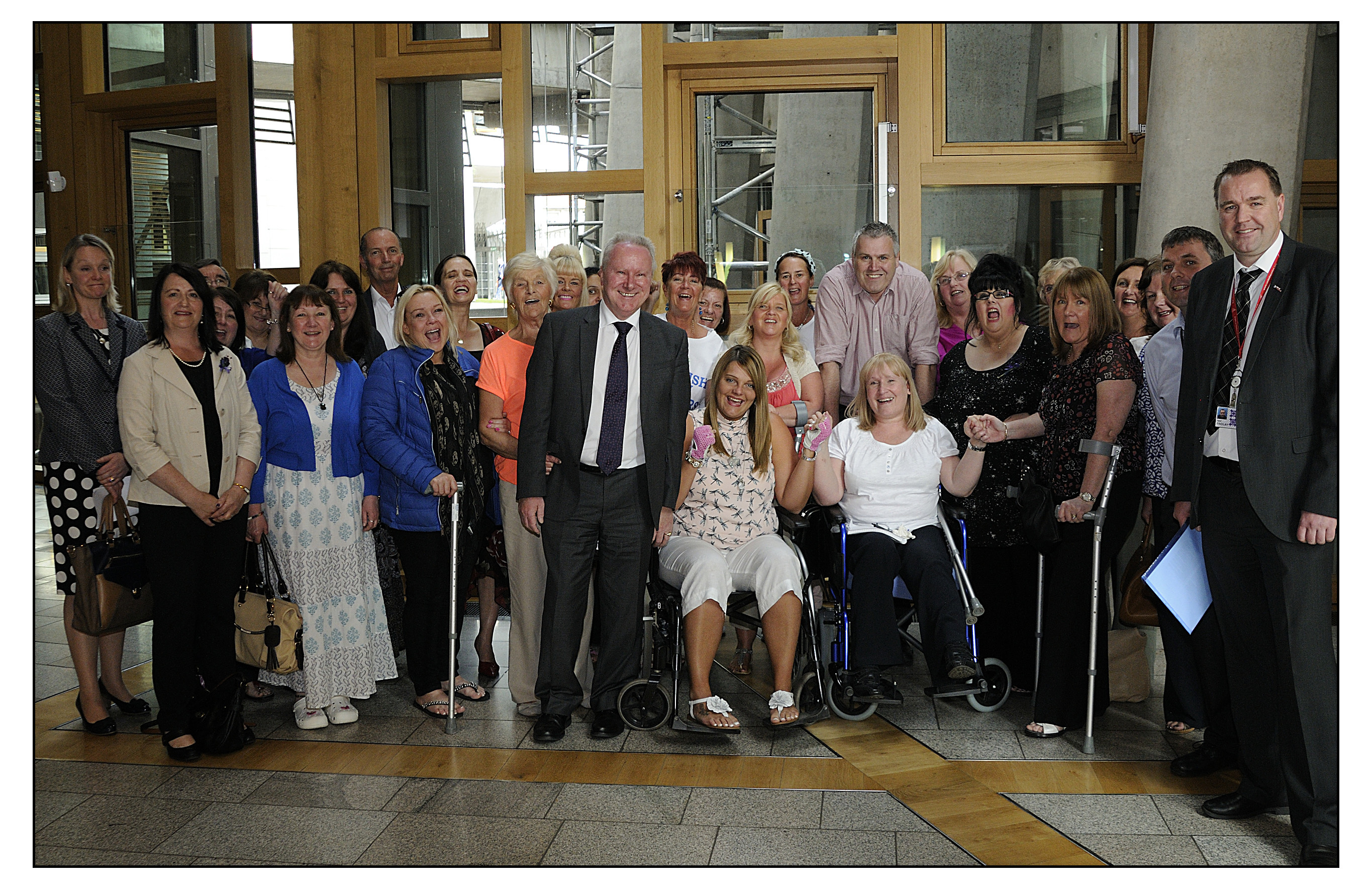 Mesh survivors group with Alex Neil (centre) and Neil Findlay MSP (Pic: Callum Moffat)