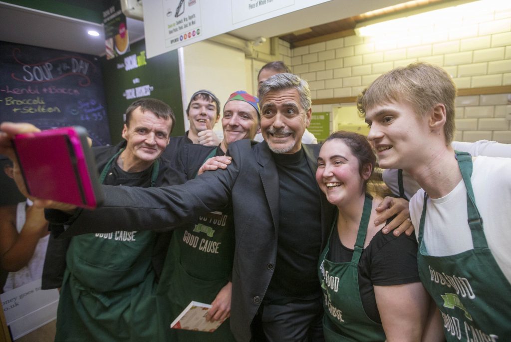 George Clooney taking a selfie with staff as he visits Social Bite (PA)