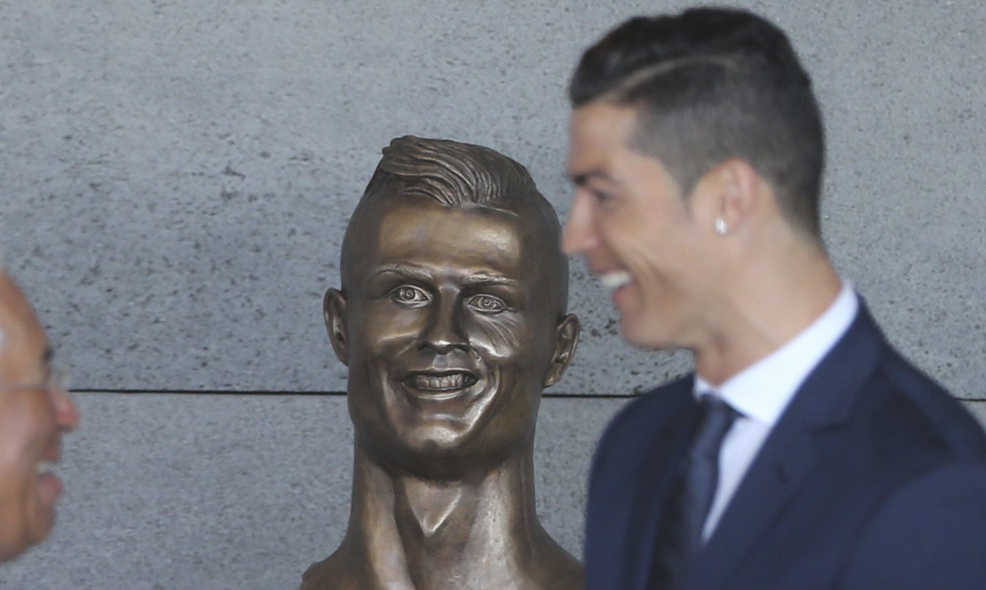 Cristiano Ronaldo and the statue (AP Photo/Armando Franca)