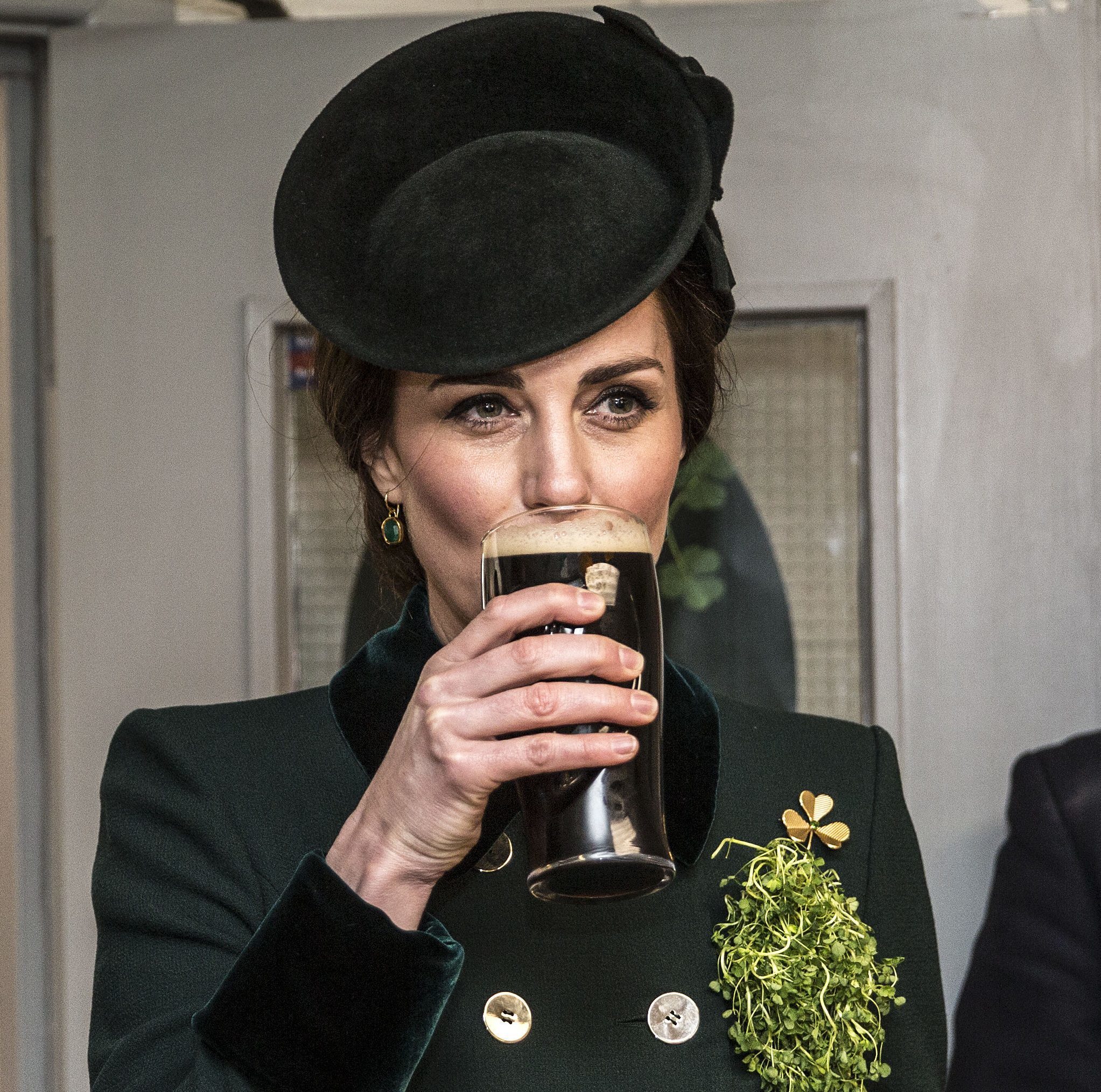 The Duchess of Cambridge takes a drink of Guinness as she meets with soldiers of the 1st Battalion Irish Guards in their canteen following their St Patrick's Day parade at Cavalry Barracks, Hounslow (Yui Mok/PA Wire)
