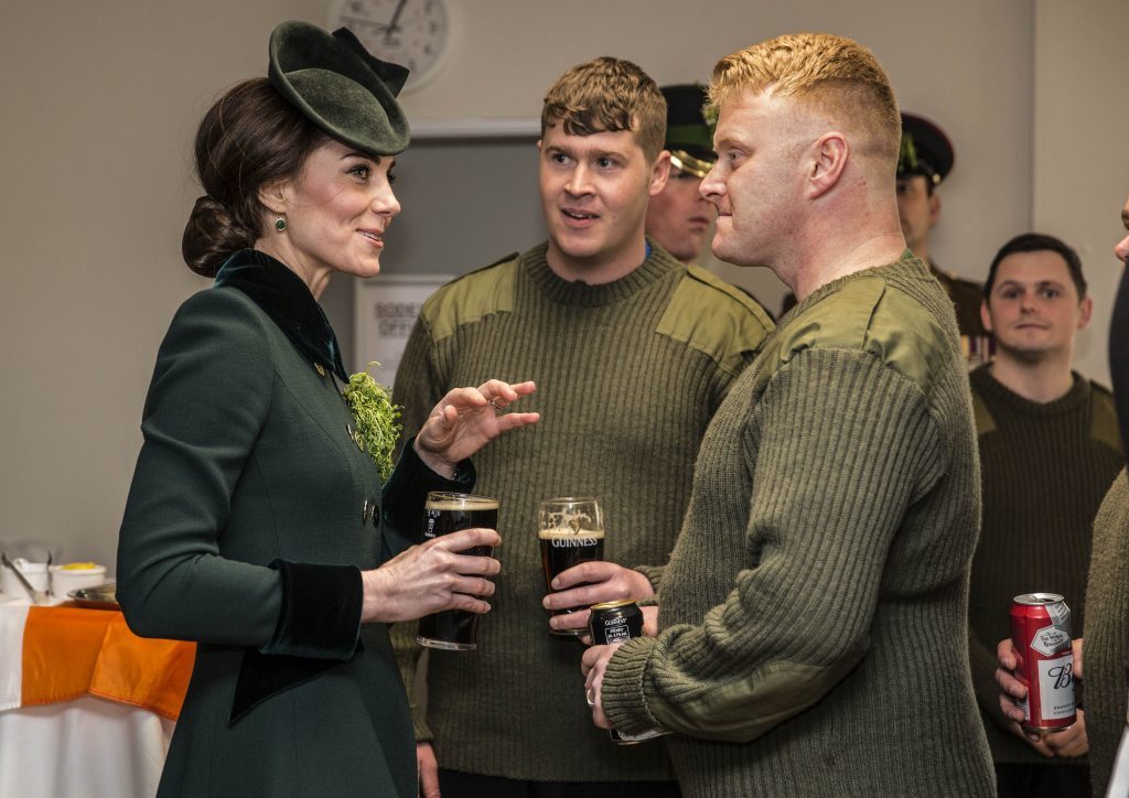 The Duchess of Cambridge stands with a pint of Guinness in her hand as she meets with soldiers of the 1st Battalion Irish Guards in their canteen following their St Patrick's Day parade at Cavalry Barracks, Hounslow. PRESS ASSOCIATION Photo. Picture date: Friday March 17, 2017. See PA story ROYAL Cambridge. Photo credit should read: Yui Mok/PA Wire
