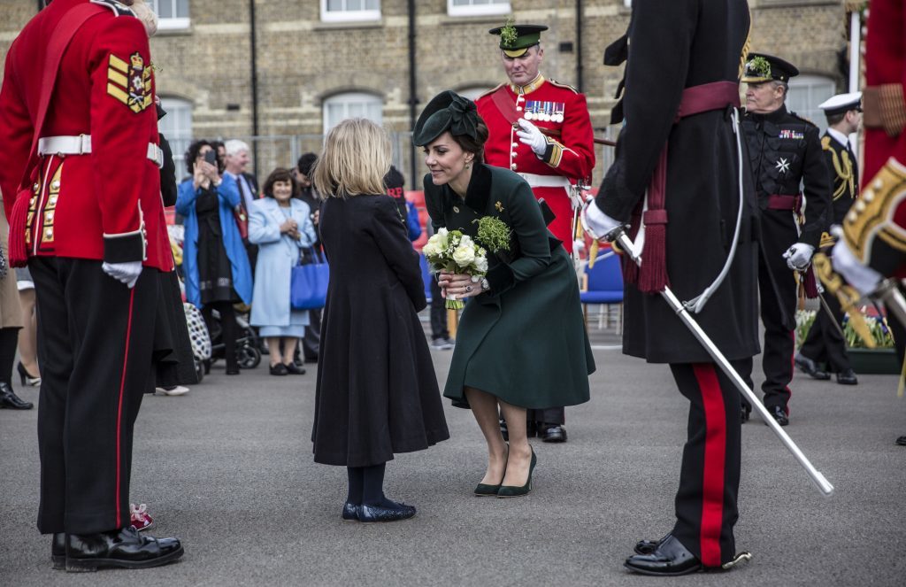 Seven year old Katy Lorimer presents flowers to The Duchess of Cambridge following the St Patrick's Day parade with the 1st Battalion the Irish Guards at Cavalry Barracks, Hounslow. PRESS ASSOCIATION Photo. Picture date: Friday March 17, 2017. See PA story ROYAL Cambridge. Photo credit should read: Yui Mok/PA Wire