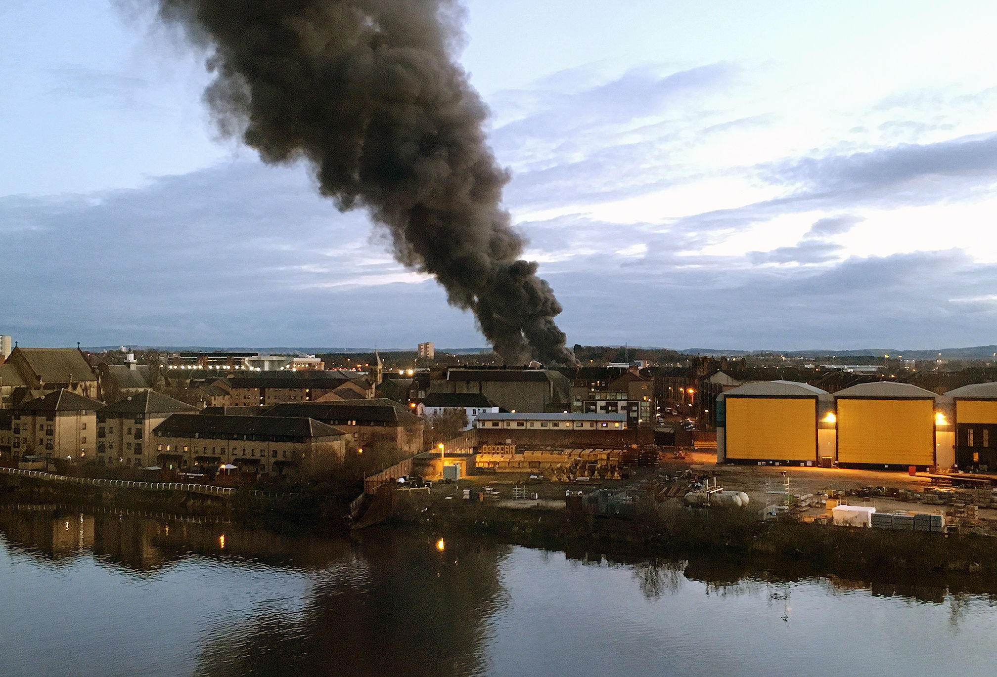 Smoke seen from Glasgow Harbour from a fire at Japanese Autoparts on Helen Street in Glasgo (Beth Edmonston/PA Wire)