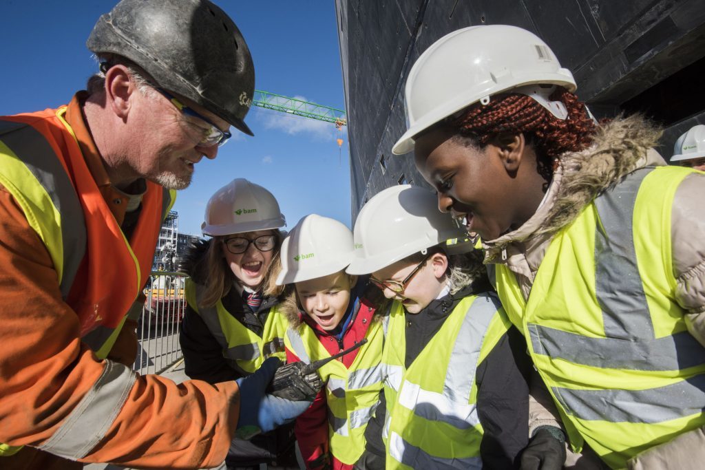 Site foreman Sean McGee holding a radio as local school pupils (left to right) Sarah McGillivary, Jak Adams, Dominic Nelson and Fiona Okeke direct a crane driver to position a Douglas Fir tree at the highest point of the building during the topping-out ceremony for the V&A Museum of Design Dundee. (Alan Richardson/PA Wire)