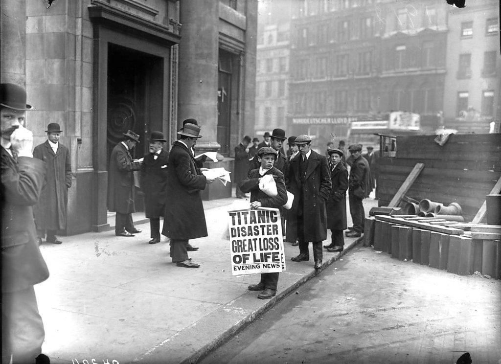 Newspaper boy Ned Parfett sells copies of the Evening News telling of the Titanic maritime disaster outside the White Star Line offices in London (Topical Press Agency/Getty Images)