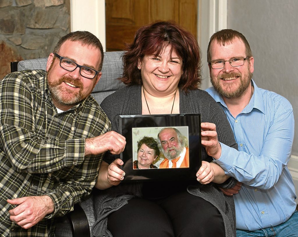 Peter Hay, Evelyn and Stephen Lawson with photograph of parents Alex and Joan Hay (Trevor Marton)