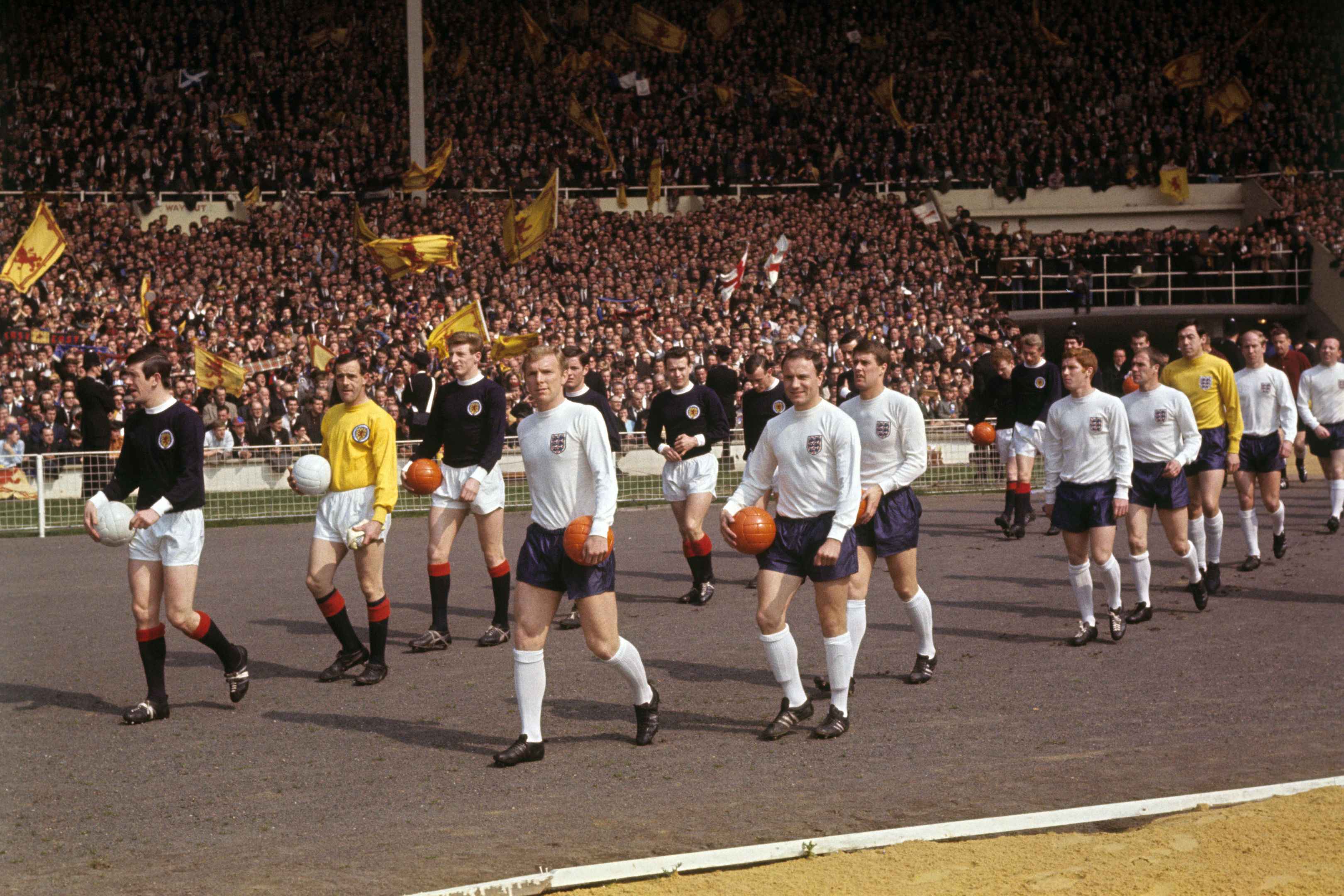 Scotland captain John Greig and England captain Bobby Moore lead out their teams ahead of the kick off (PA Wire/Press Association Images)