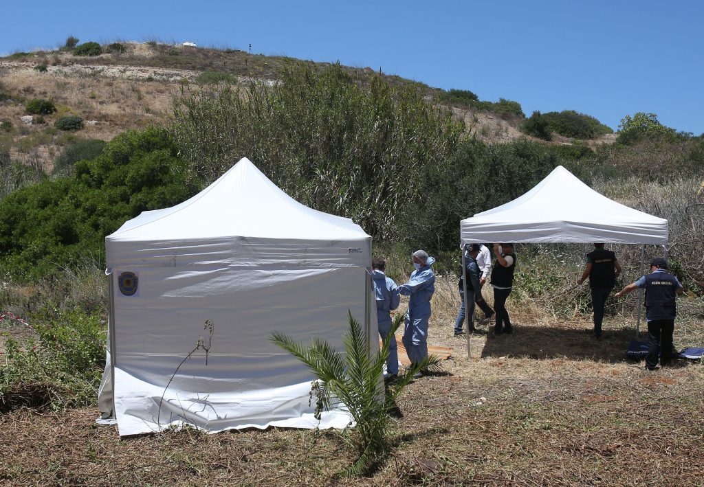 Forensic police officers investigating the disappearance of Madeleine McCann examining an area of wasteland outside the town of Praia da Luz in Portugal. (Nick Ansell/PA Wire)