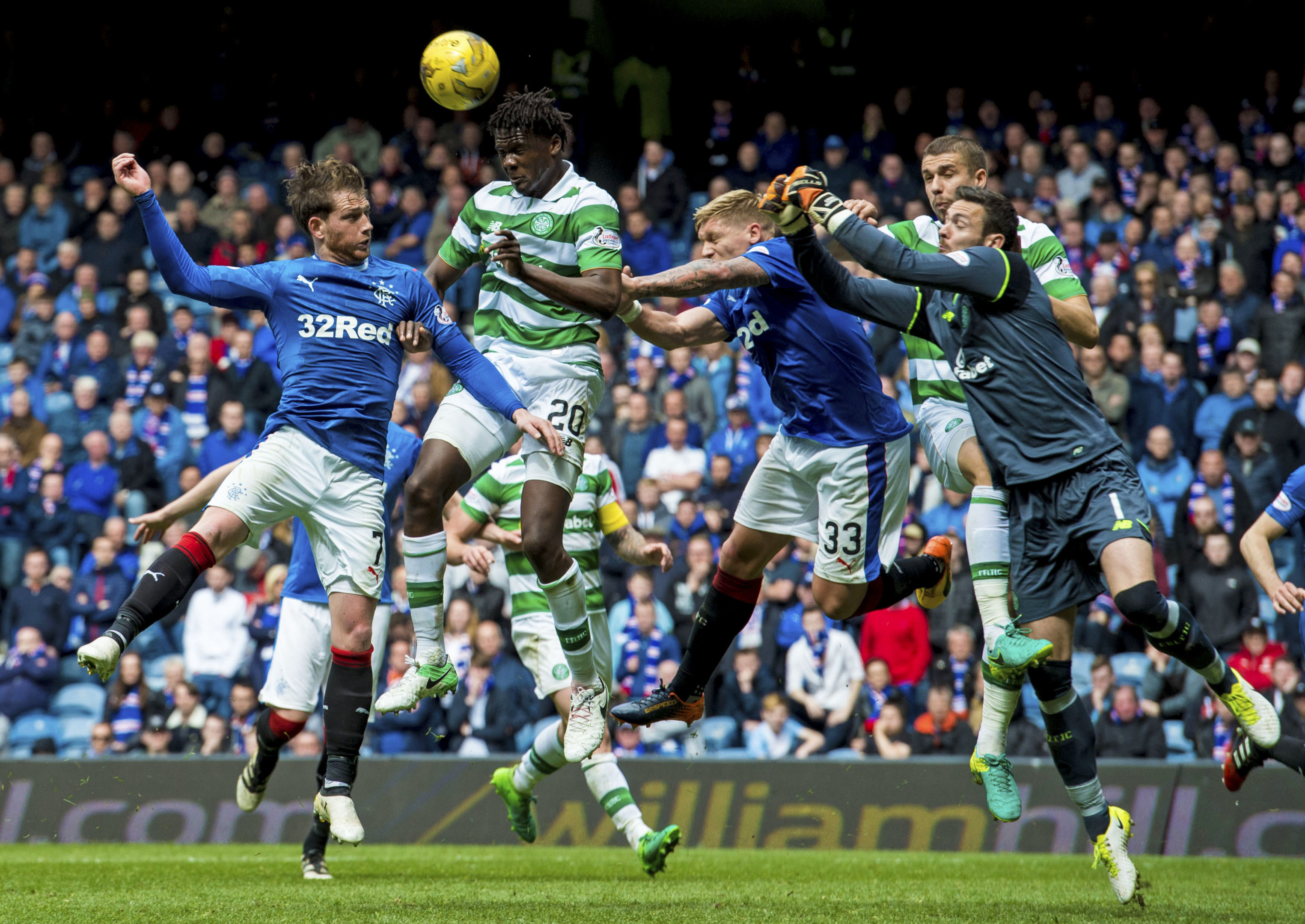 Celtic's Dedryck Boyata heads clear under pressure from Rangers' Joe Garner (SNS)