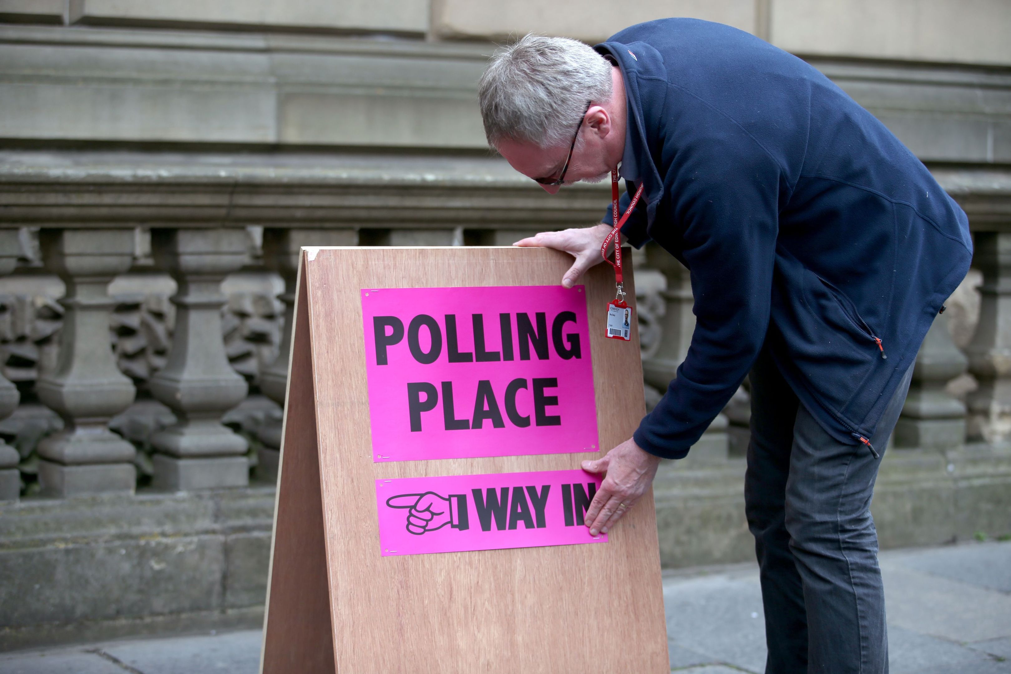 Polling logistics officer Roy Drury secures a polling station sign from Lothian Chambers in Edinburgh (Jane Barlow/PA Wire)