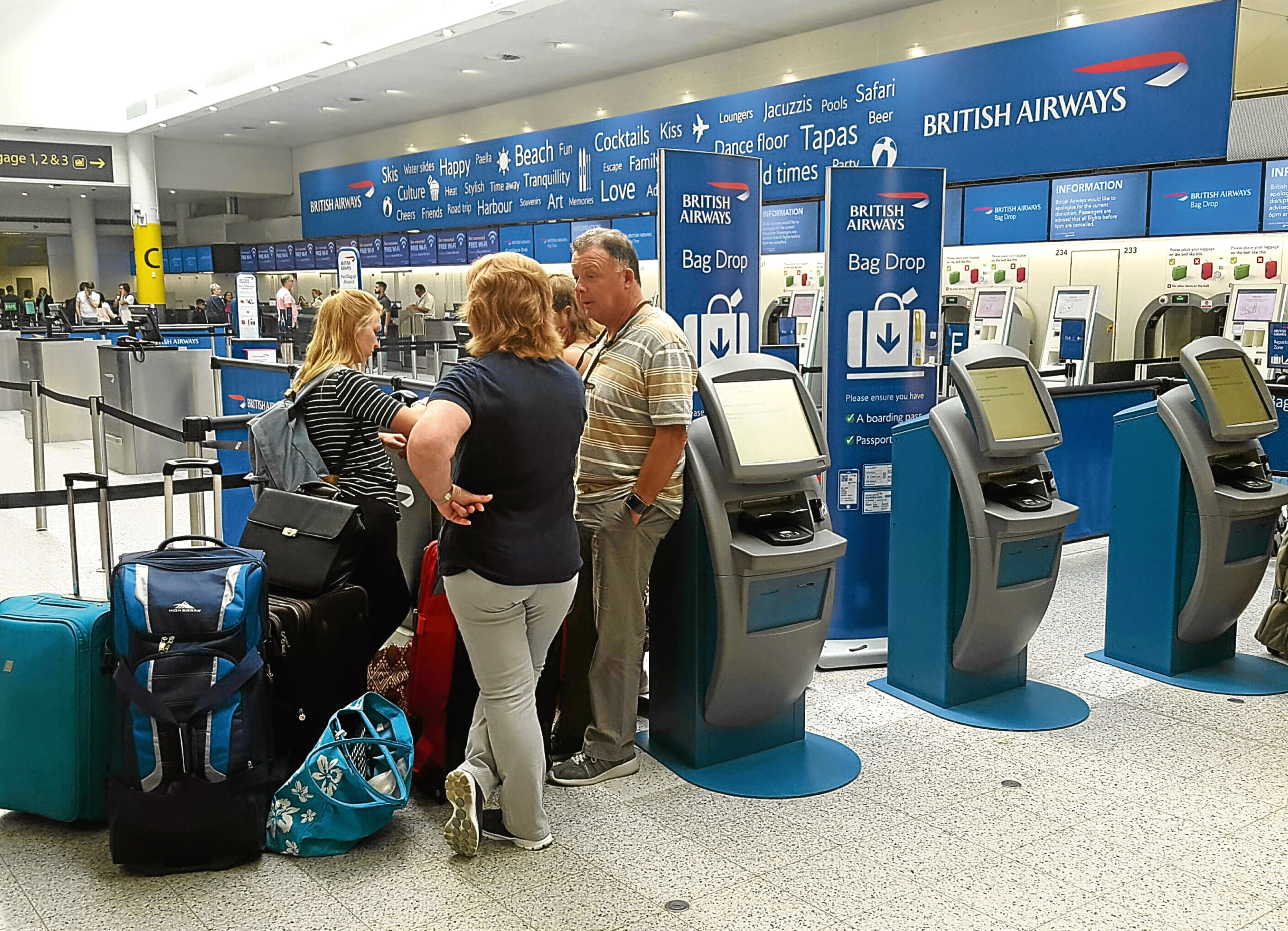 Passengers at the British Airways check-in desk at Gatwick Airport. The airline says it has cancelled all flights leaving from Heathrow and Gatwick for the rest of today because of a "major IT system failure". (Gareth Fuller/PA Wire)