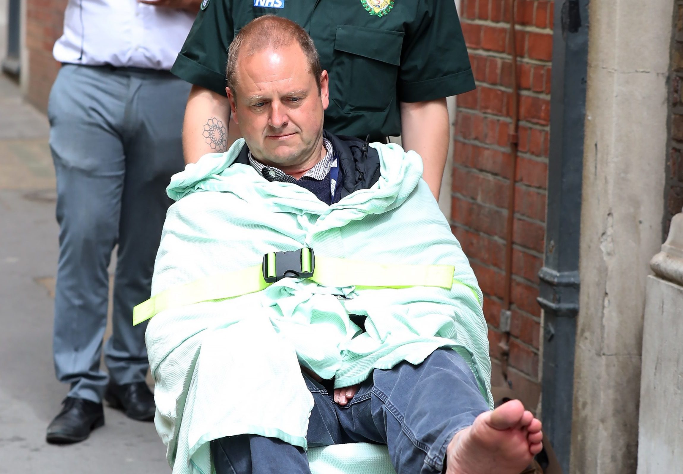 BBC Cameraman Giles Wooltorton is helped by Ambulance staff after reportedly being hit by Labour Leader Jeremy Corbyn's vehicle outside Savoy Place (Neil P. Mockford/Getty Images)