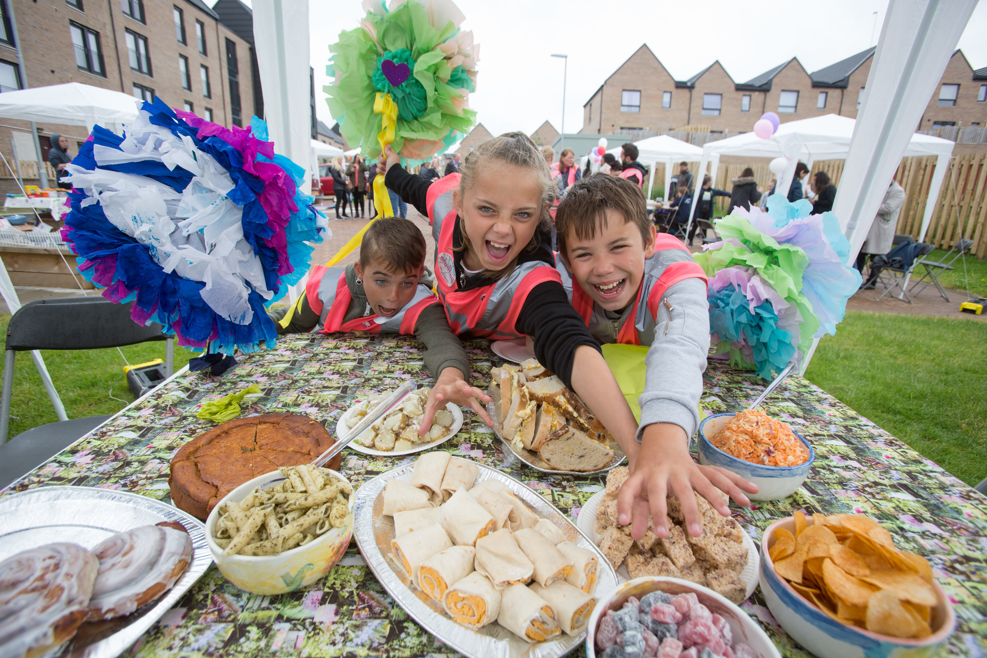 Local youngsters Robert Wilson 12 , Courtney Wilson 10 and John Wilkie 10 help themselves to food at the eighth annual Big Lunch, a project by the Eden Project and supported by Big Lottery Fund which took place last year. (Martin Shields)