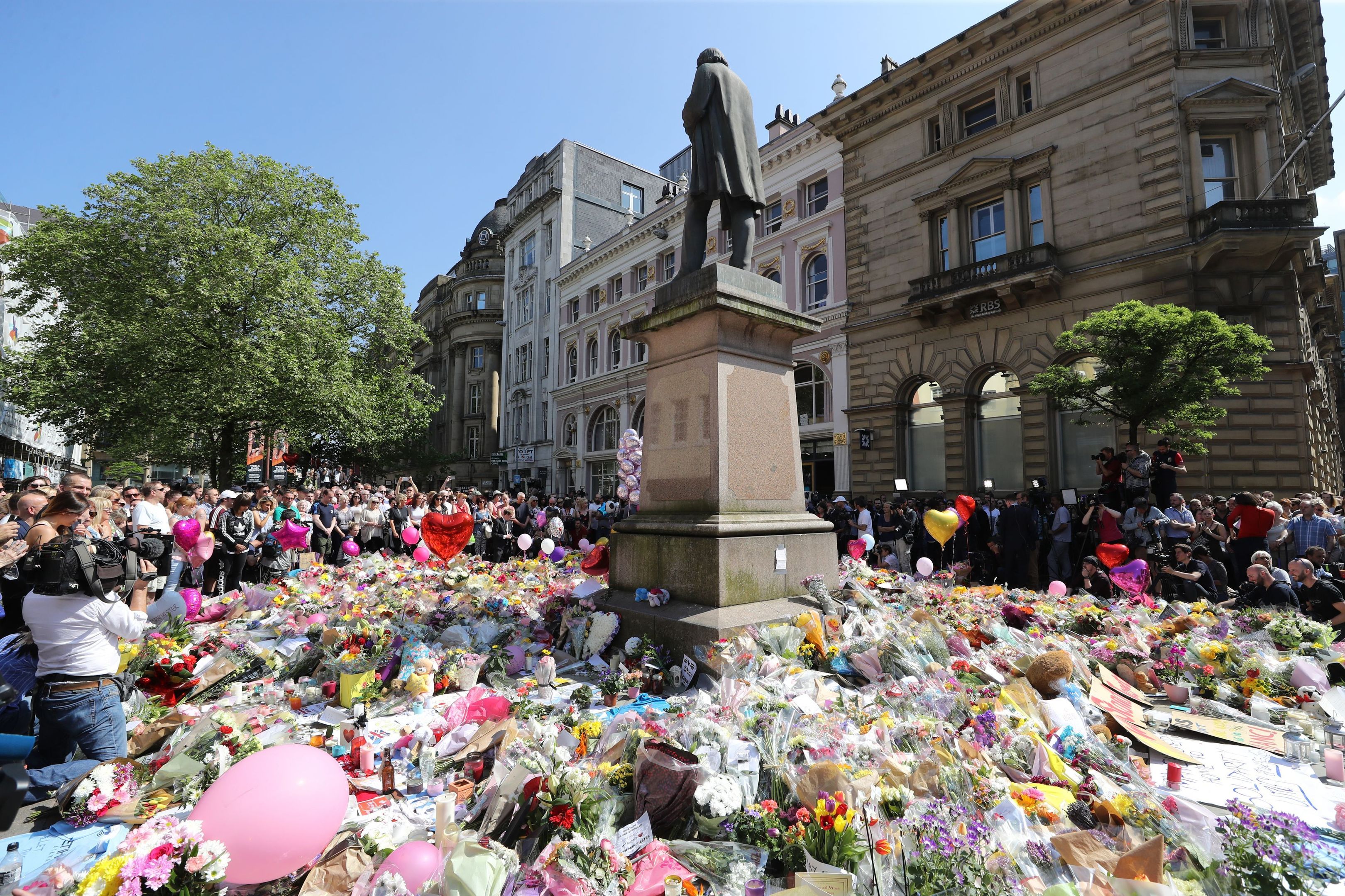 People observe a minute's silence in St Ann's Square, Manchester, to remember the victims of the terror attack in the city earlier this week. (Owen Humphreys/PA Wire)