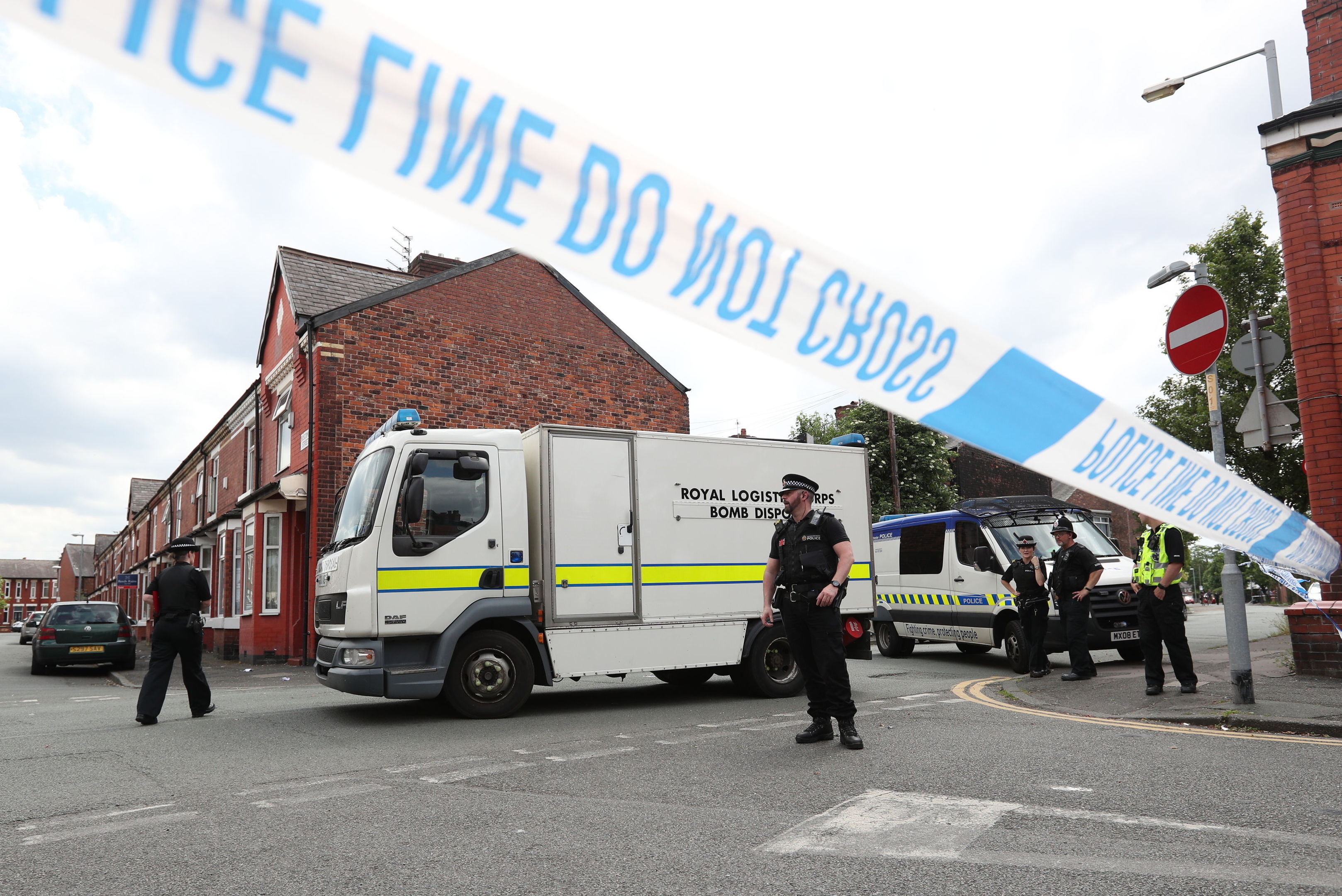 Police and a bomb disposal unit at the junction between Boscombe Street and Yew Tree Road in the Moss Side area of Manchester, after an evacuation took place as part of an ongoing search following the terror attack in the city earlier this week. (Jonathan Brady/PA Wire)