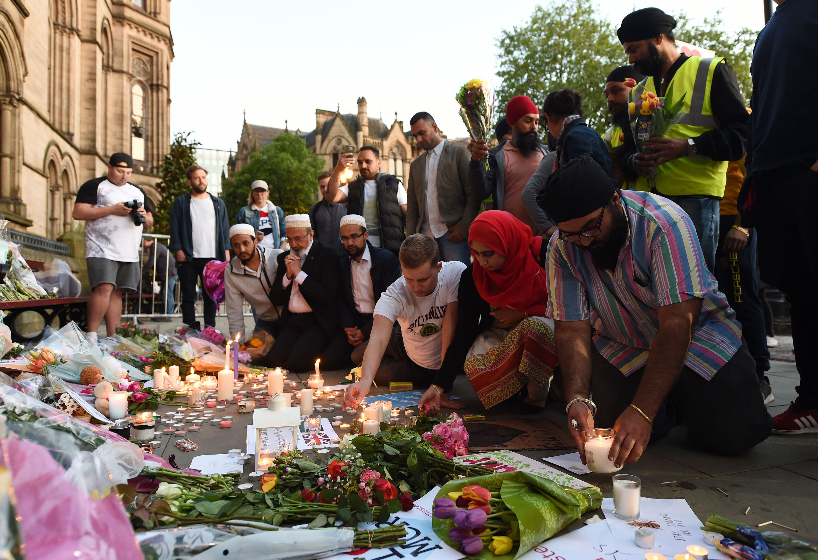People leave tributes in Albert Square, Manchester (Joe Giddens/PA Wire)