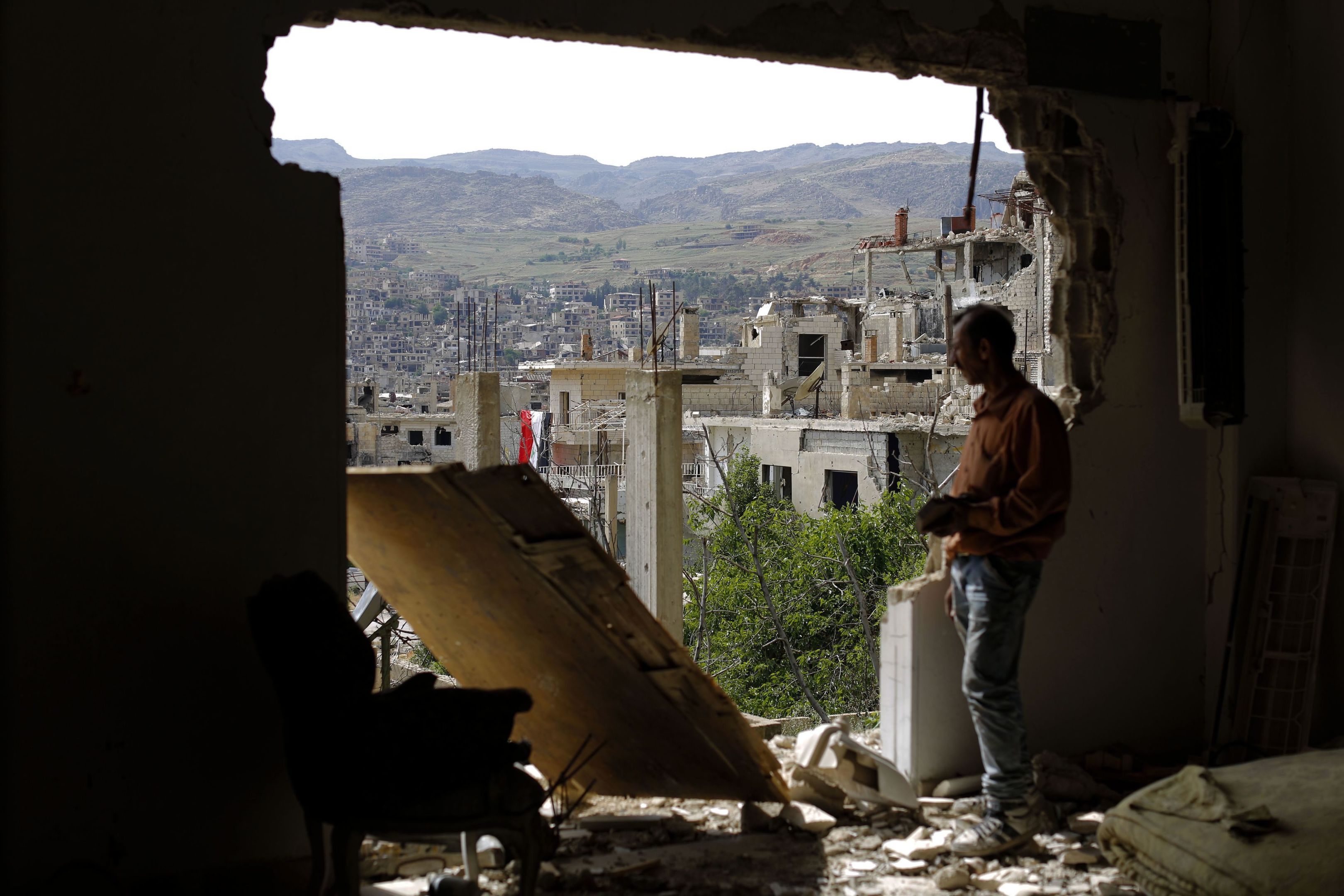 A man checks the damage at the mountain resort town of Zabadani in the Damascus countryside, Syria (AP Photo/Hassan Ammar)