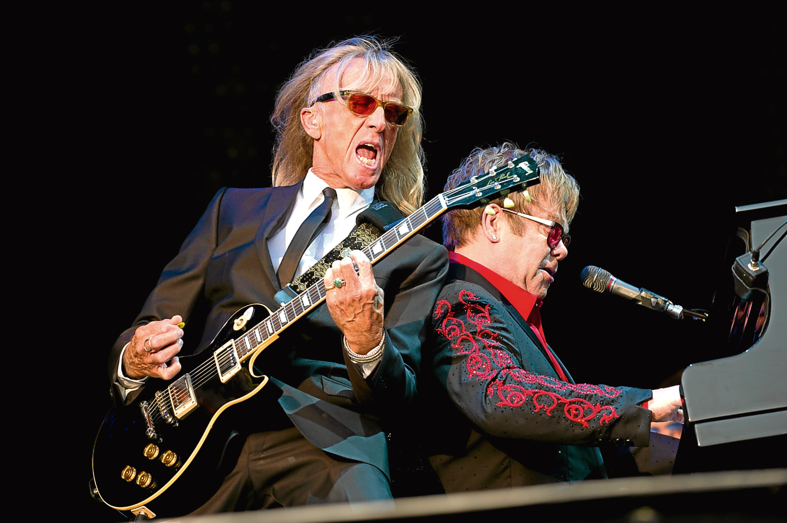 Scottish guitarist Davey Johnstone (L) performing with Elton John (Emily Wabitsch / DPA/PA Images)