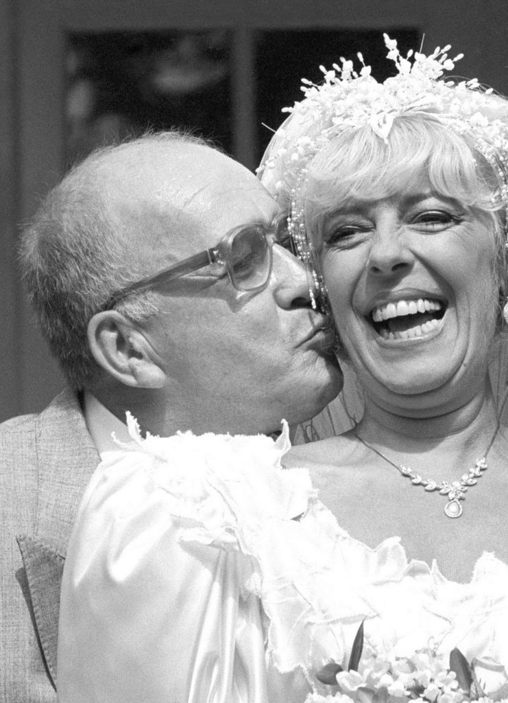 Coronation Street barmaid Bet Lynch (actress Julie Goodyear) getting a kiss from television groom Alec Gilroy (actor Roy Barraclough) (PA Wire)