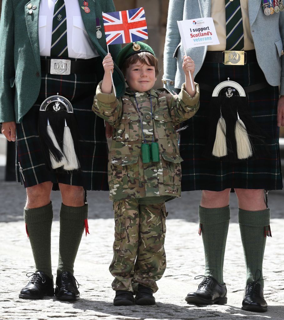 Six Year old Luca Gordon from Edinburgh with ex-service personnel from Legion Scotland after they marched down the Royal Mile during the ninth annual Armed Forces Day in Edinburgh. (Andrew Milligan/PA Wire)