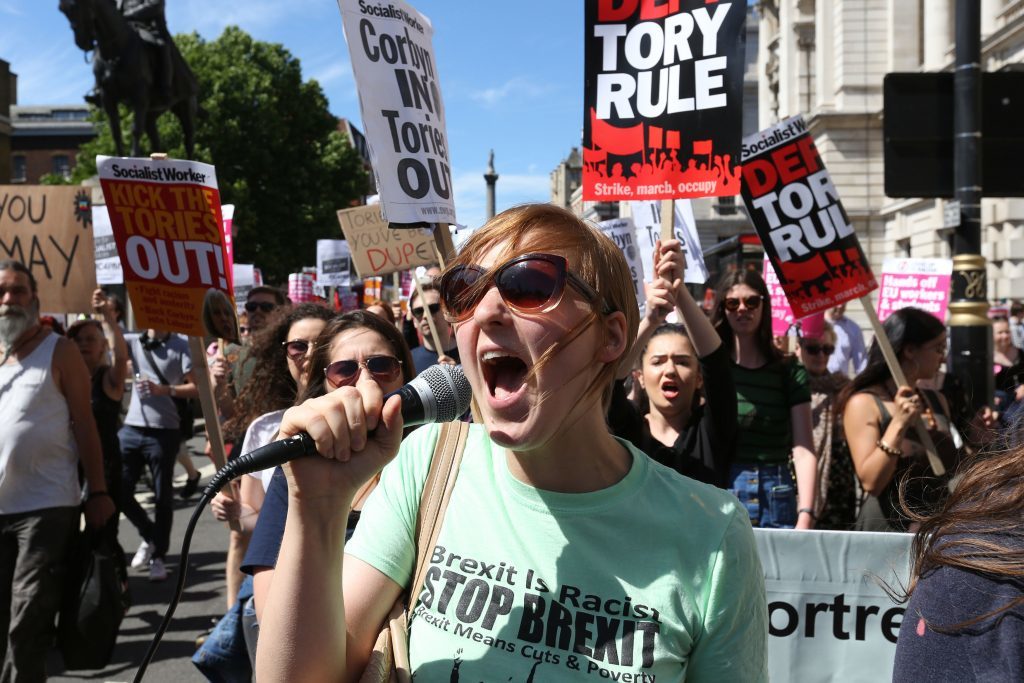Protesters have gather outside Downing Street in central London to voice their anger at Theresa May's government and her alliance with the Democratic Unionist Party. (Rick Findler/PA Wire)