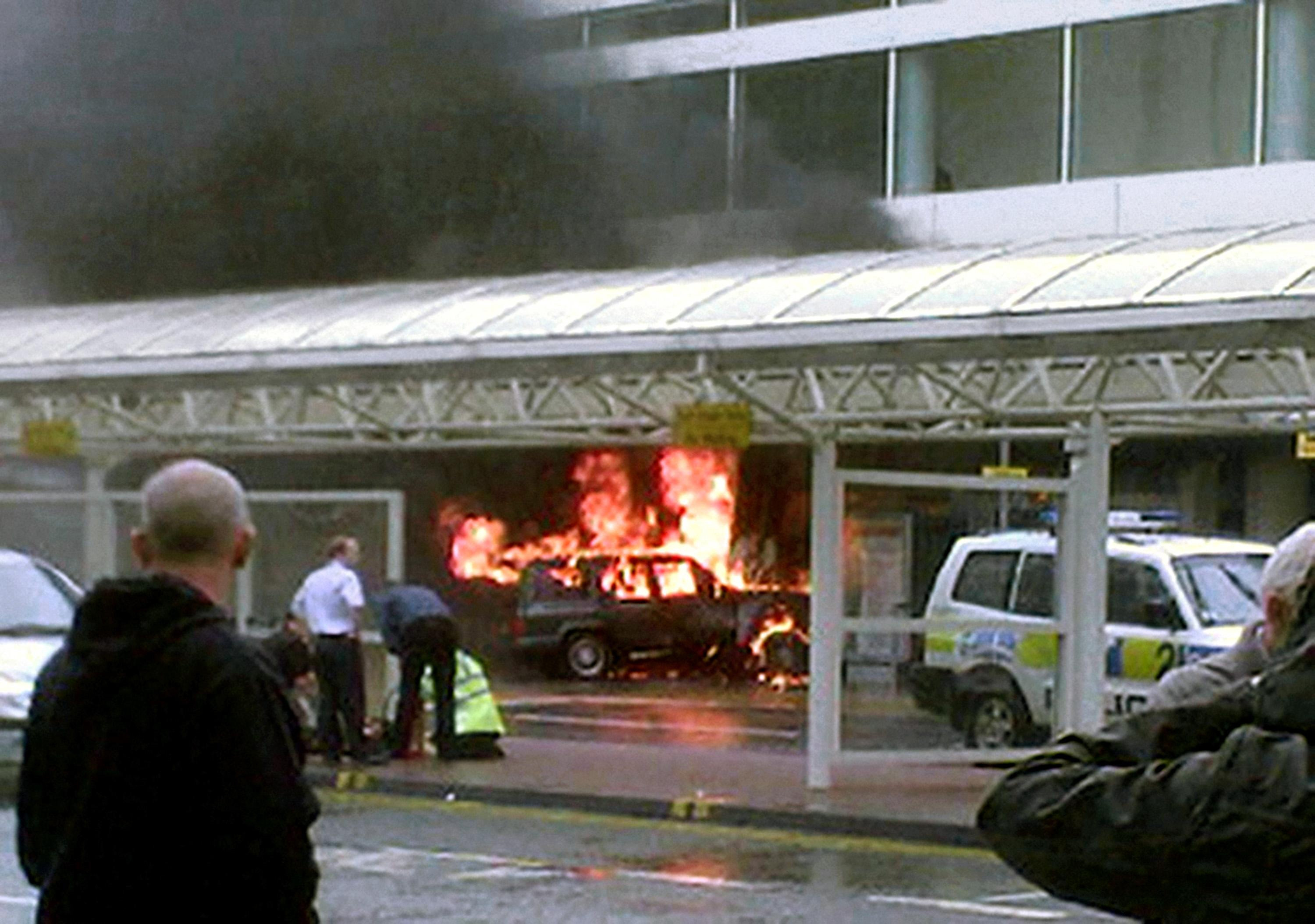 Flames rise from a Cherokee jeep after the terrorist car bomb attack on Glasgow airport (PA)