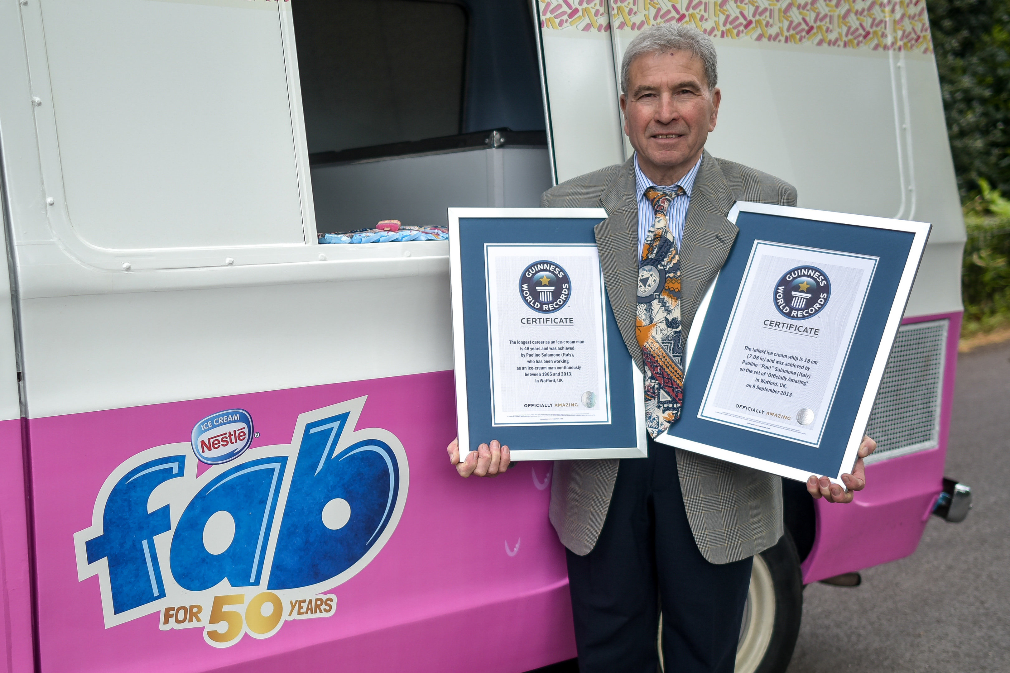 Paul Salamone beside the Fab Ice Cream van with his Guinness World Records, for Longest Serving Ice Cream man and Tallest ice cream (SWNS)