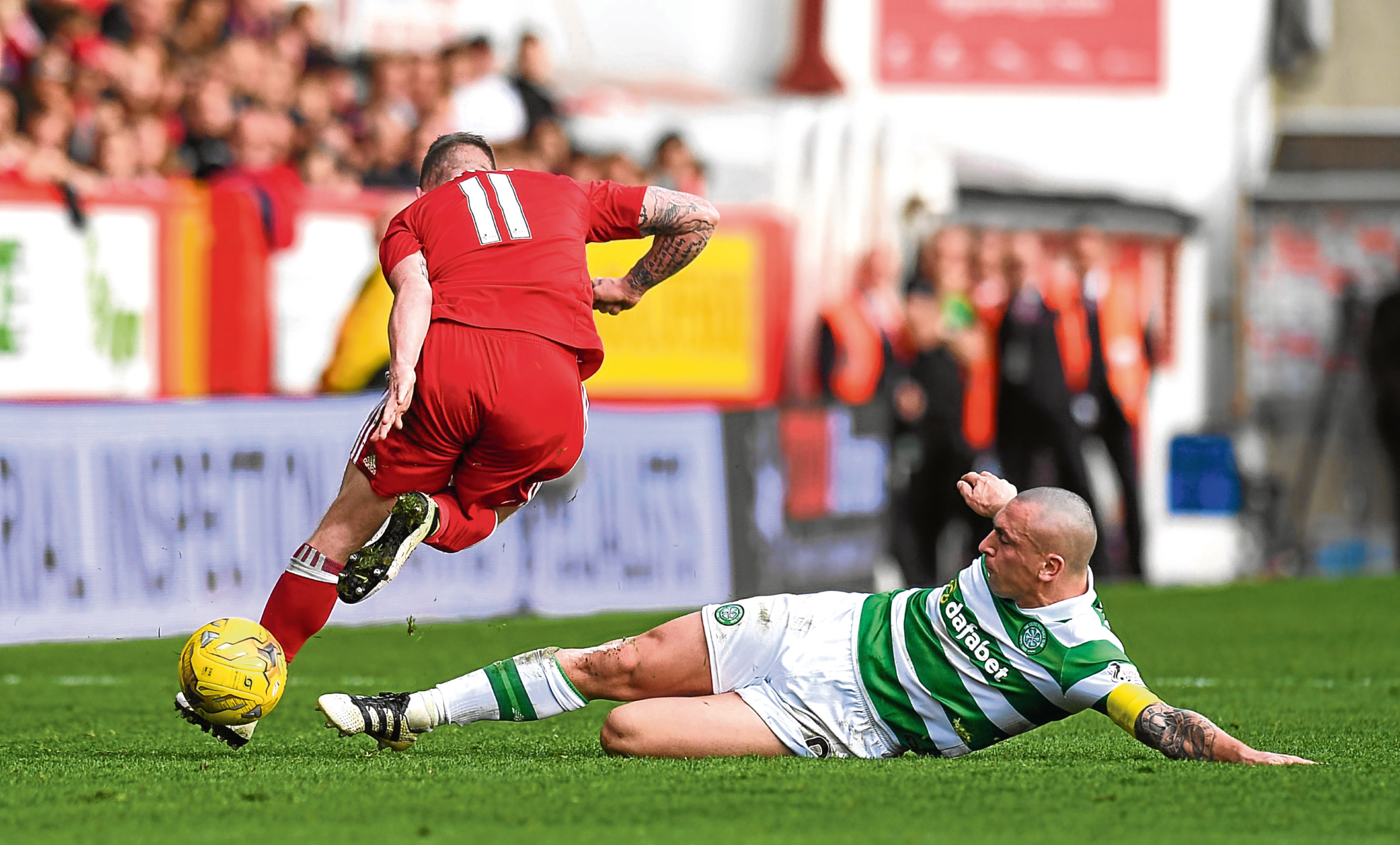 Celtic's Scott Brown (right) tackles Jonny Hayes last season (SNS Group)