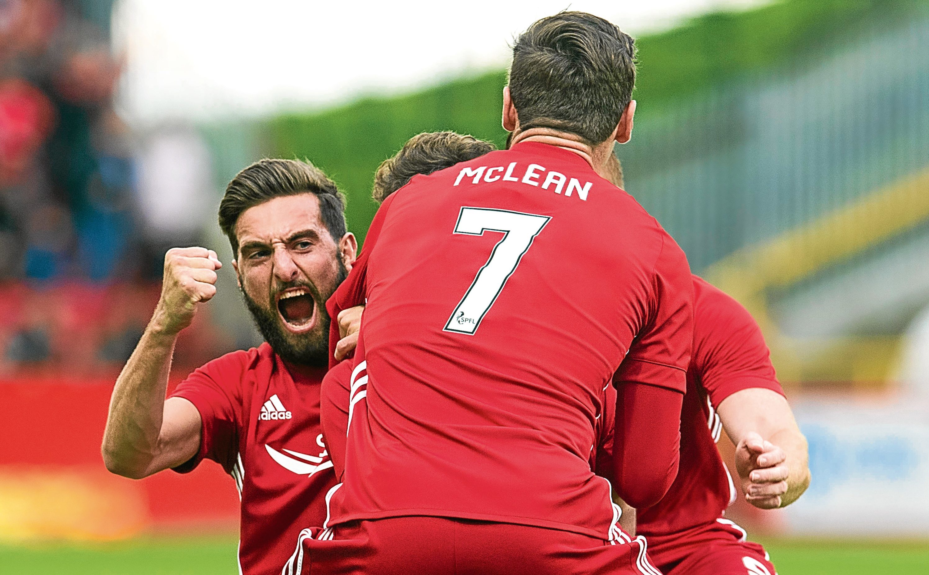 Aberdeen's Graeme Shinnie (L) and Kenny McLean surround Ryan Christie after his goal in the Europa League qualifier (SNS Group)