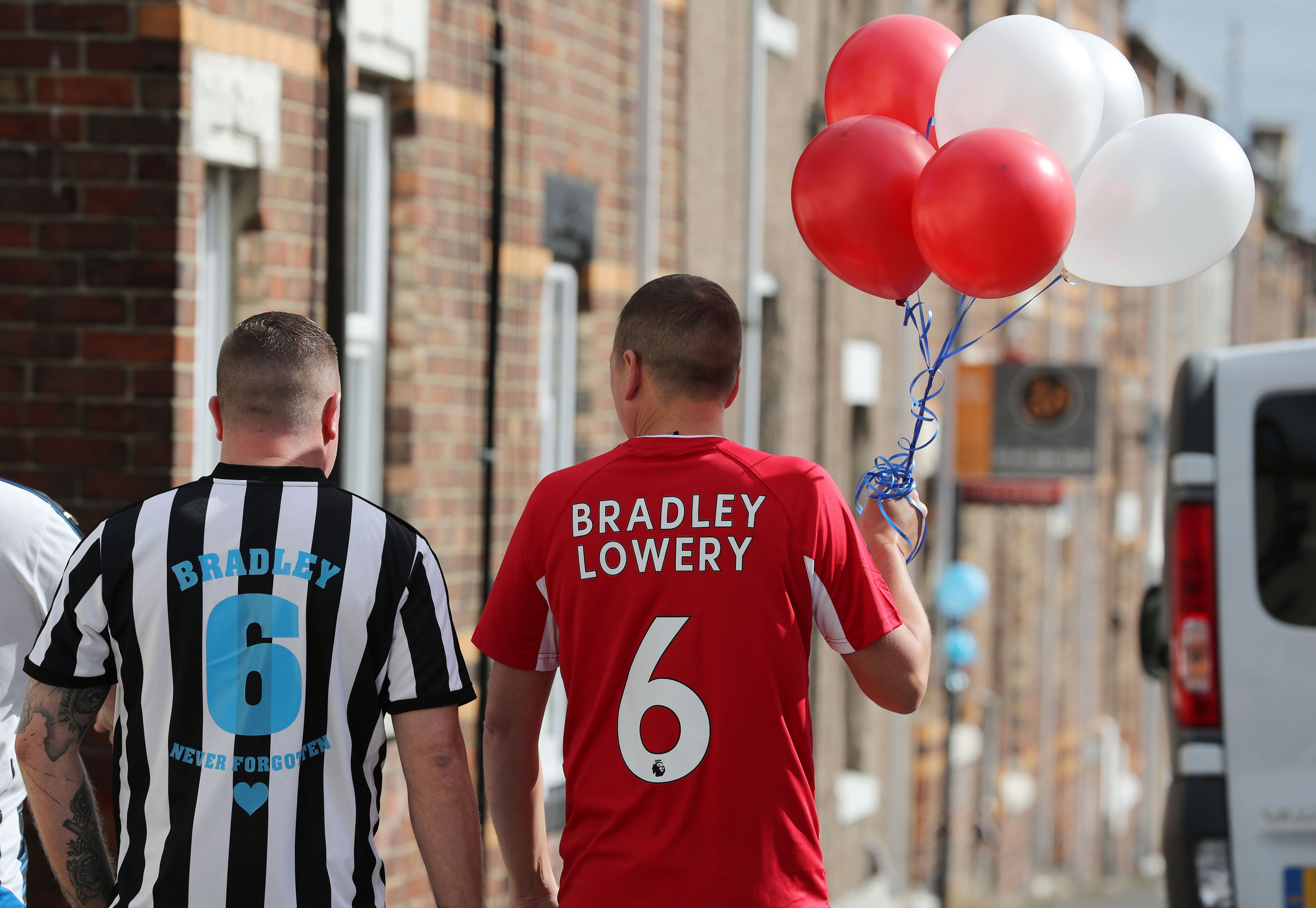 People line the route of the funeral procession with decorations ahead of the funeral of Bradley Lowery (Owen Humphreys/PA Wire)