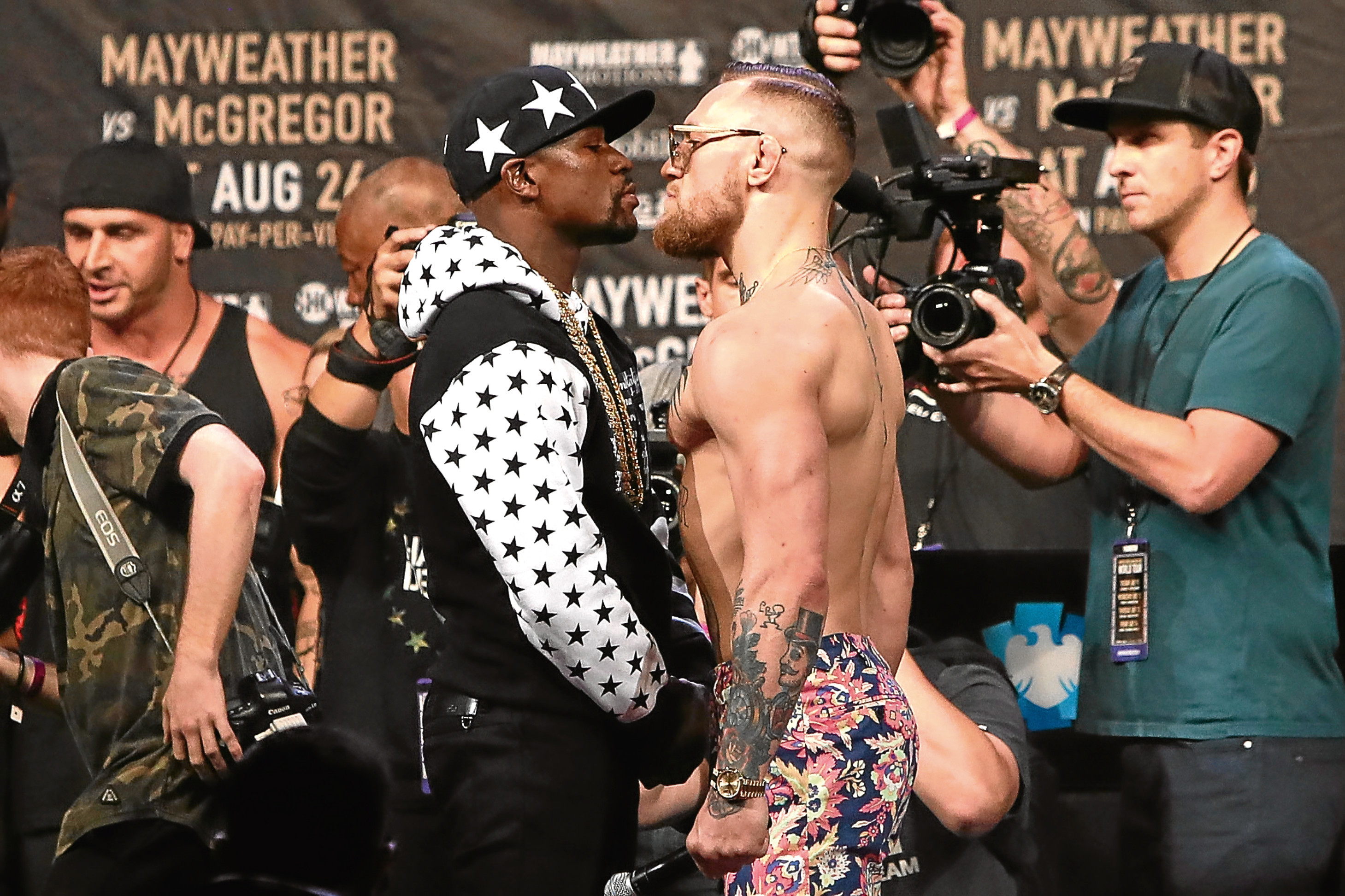 Floyd Mayweather Jr. and Conor McGregor face off  (Mike Lawrie/Getty Images)