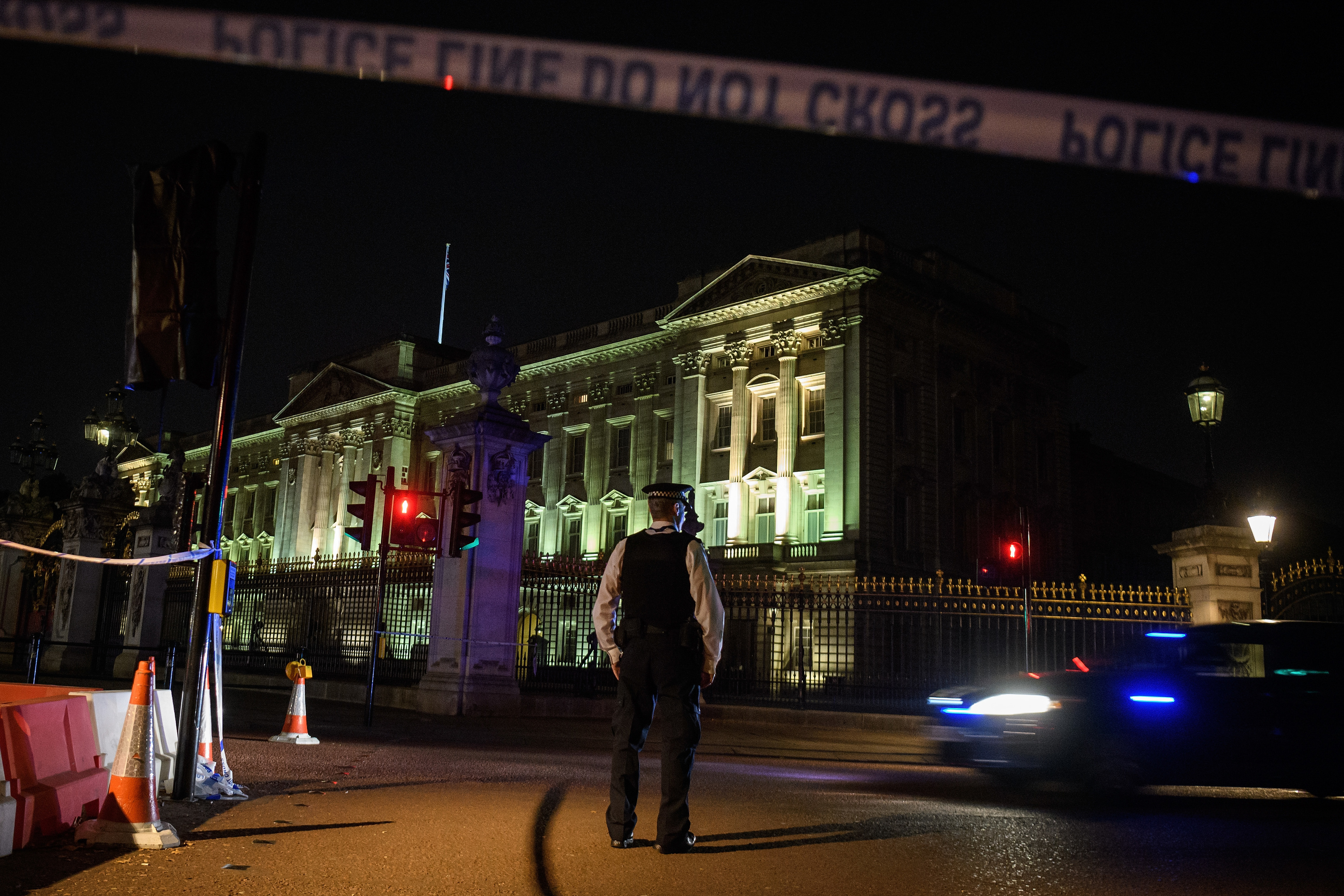 Police teams secure the roads behind a cordoned area following an attack on two police officers at Buckingham Palace (Leon Neal/Getty Images)