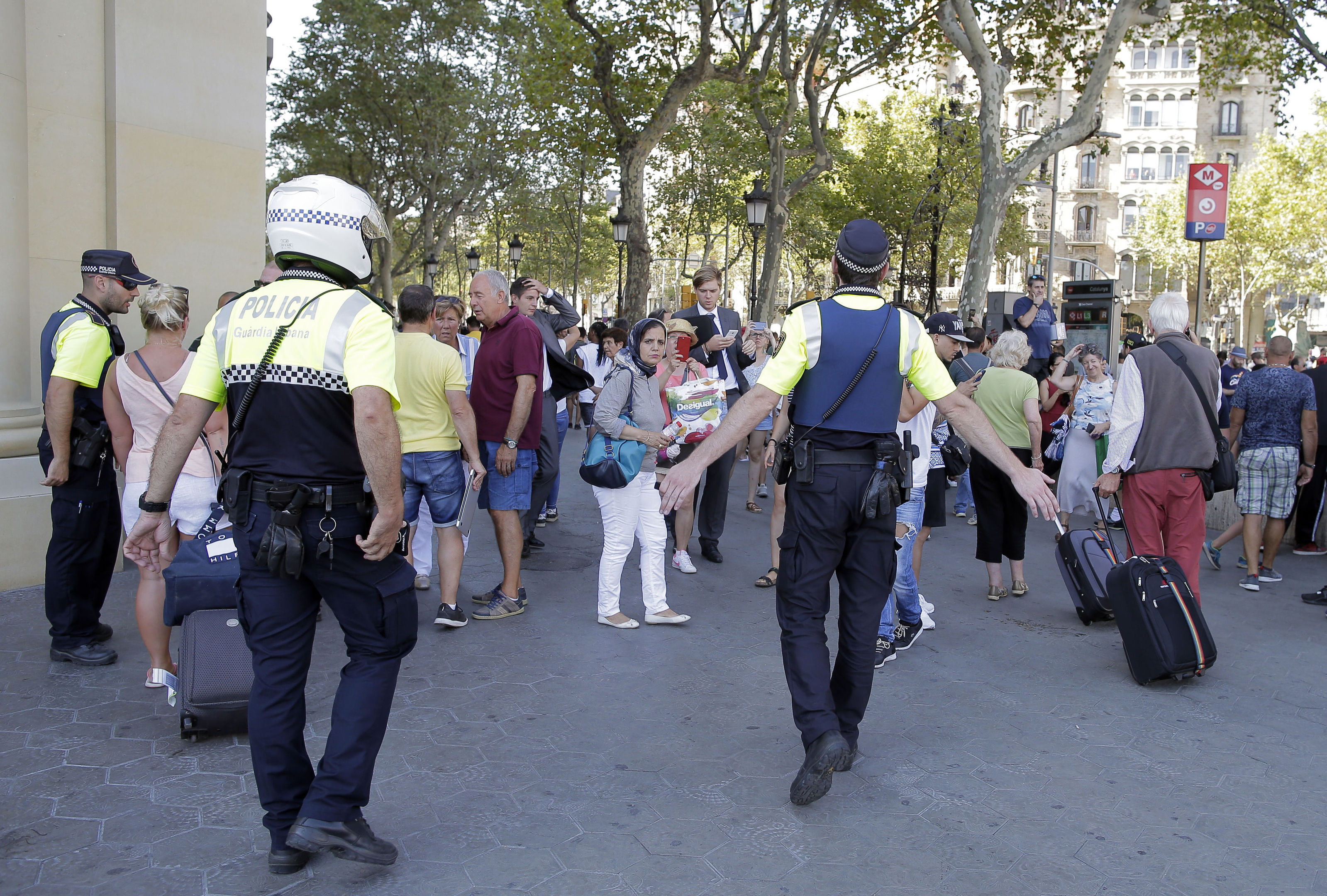 Police officers tell members of the public to leave the scene (AP Photo/Manu Fernandez)